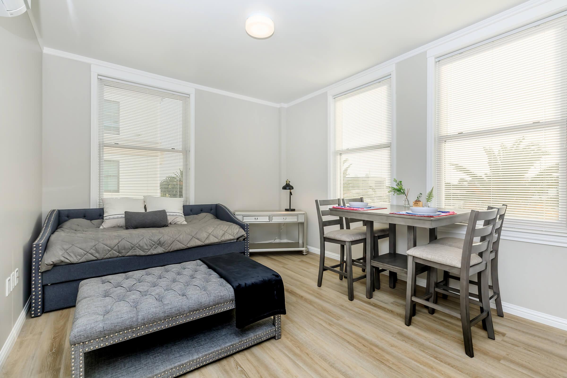 a living room filled with furniture and a large window