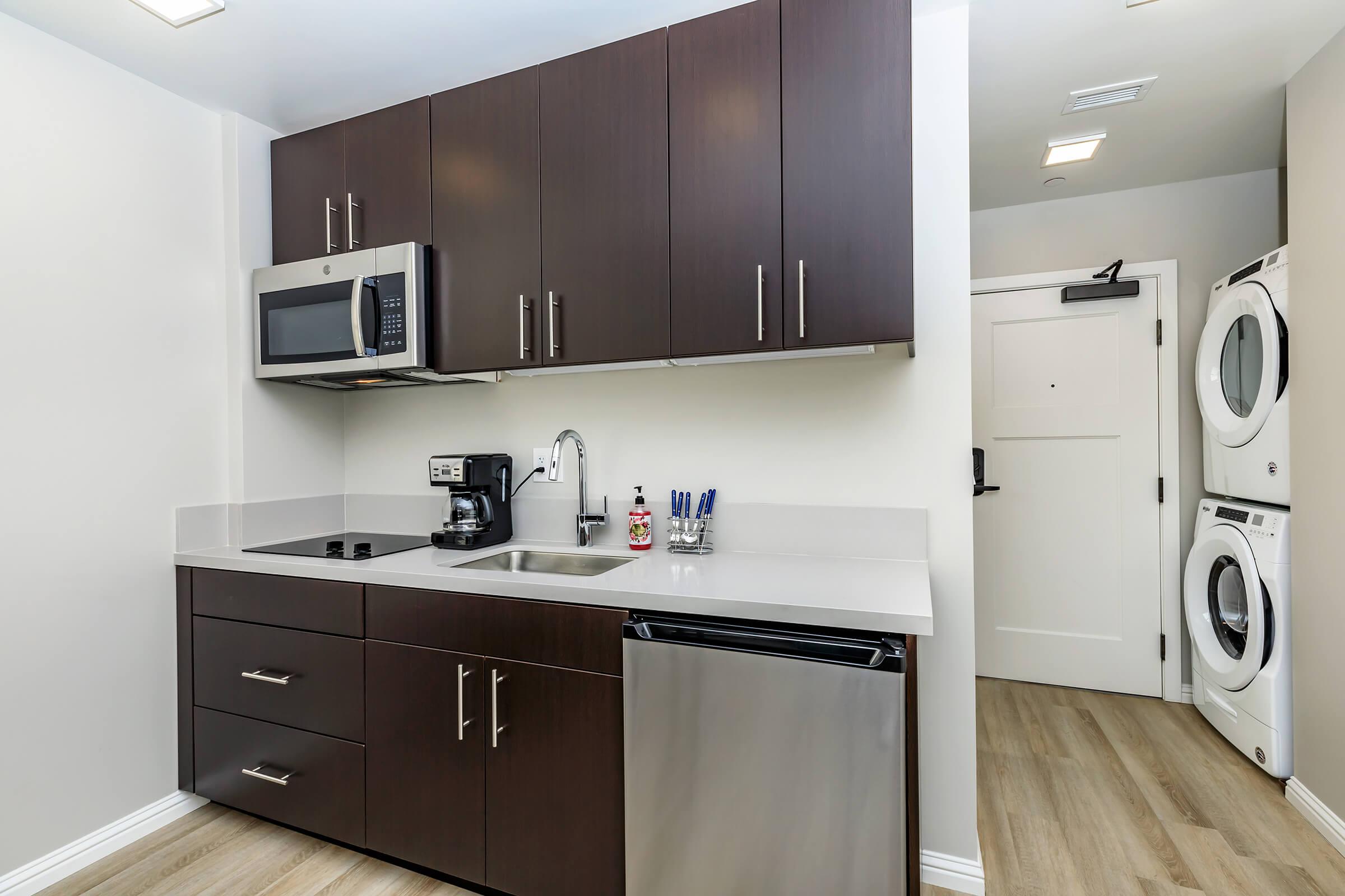 a kitchen with a sink and a refrigerator