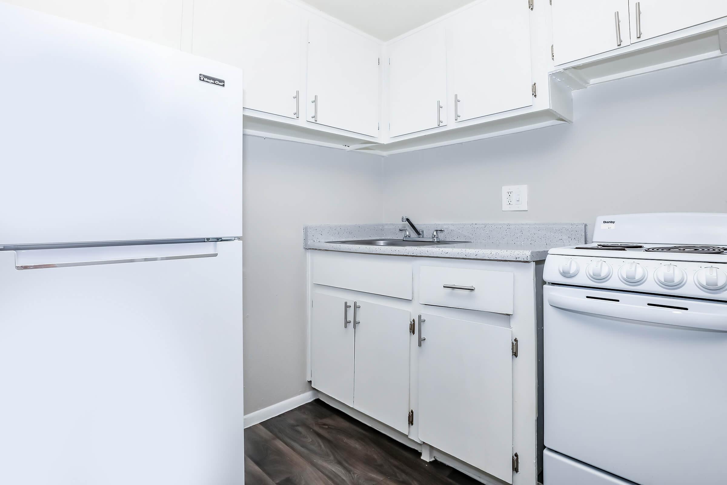 a kitchen with a sink and a refrigerator