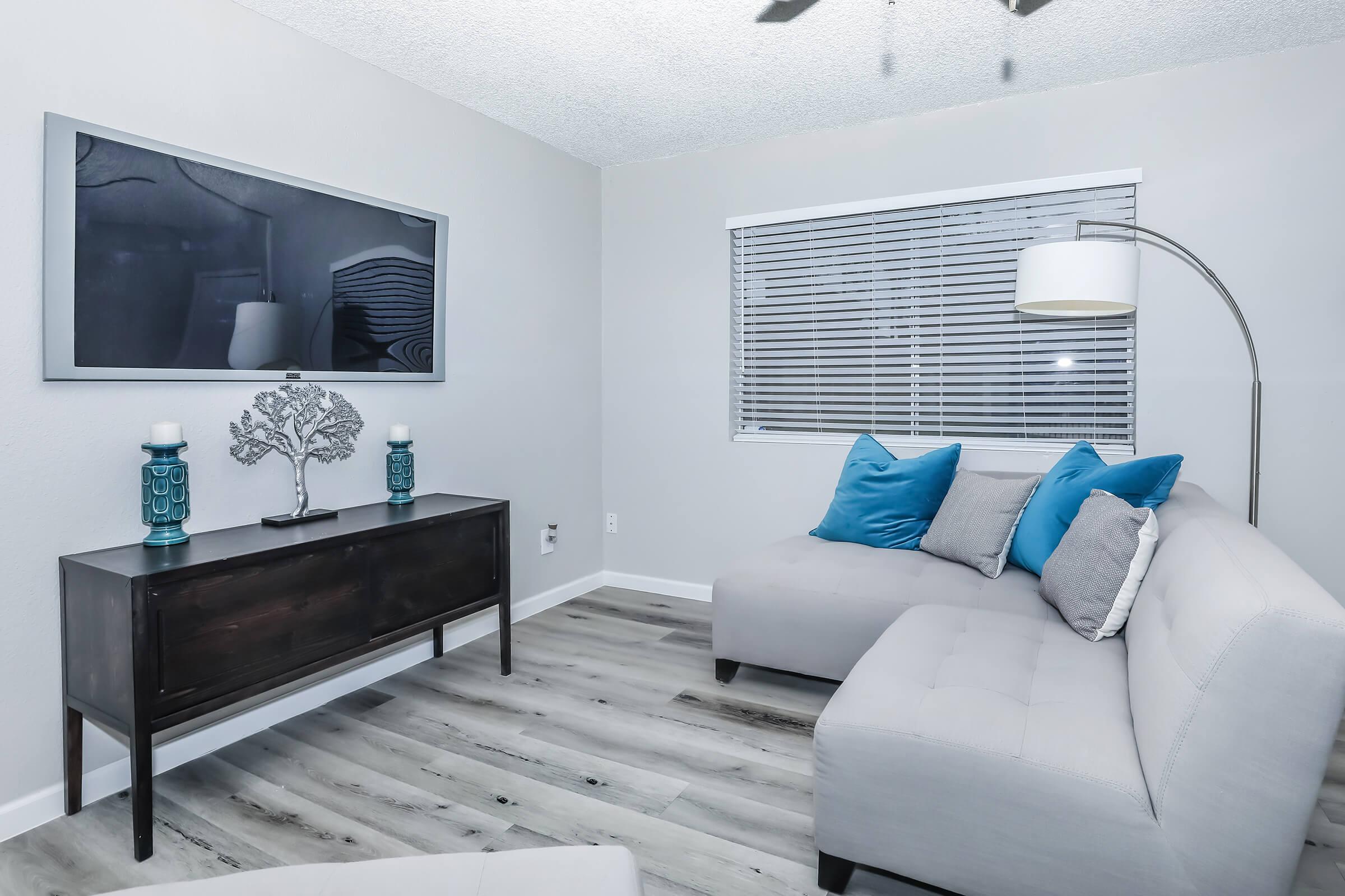 a living room filled with furniture and a flat screen tv