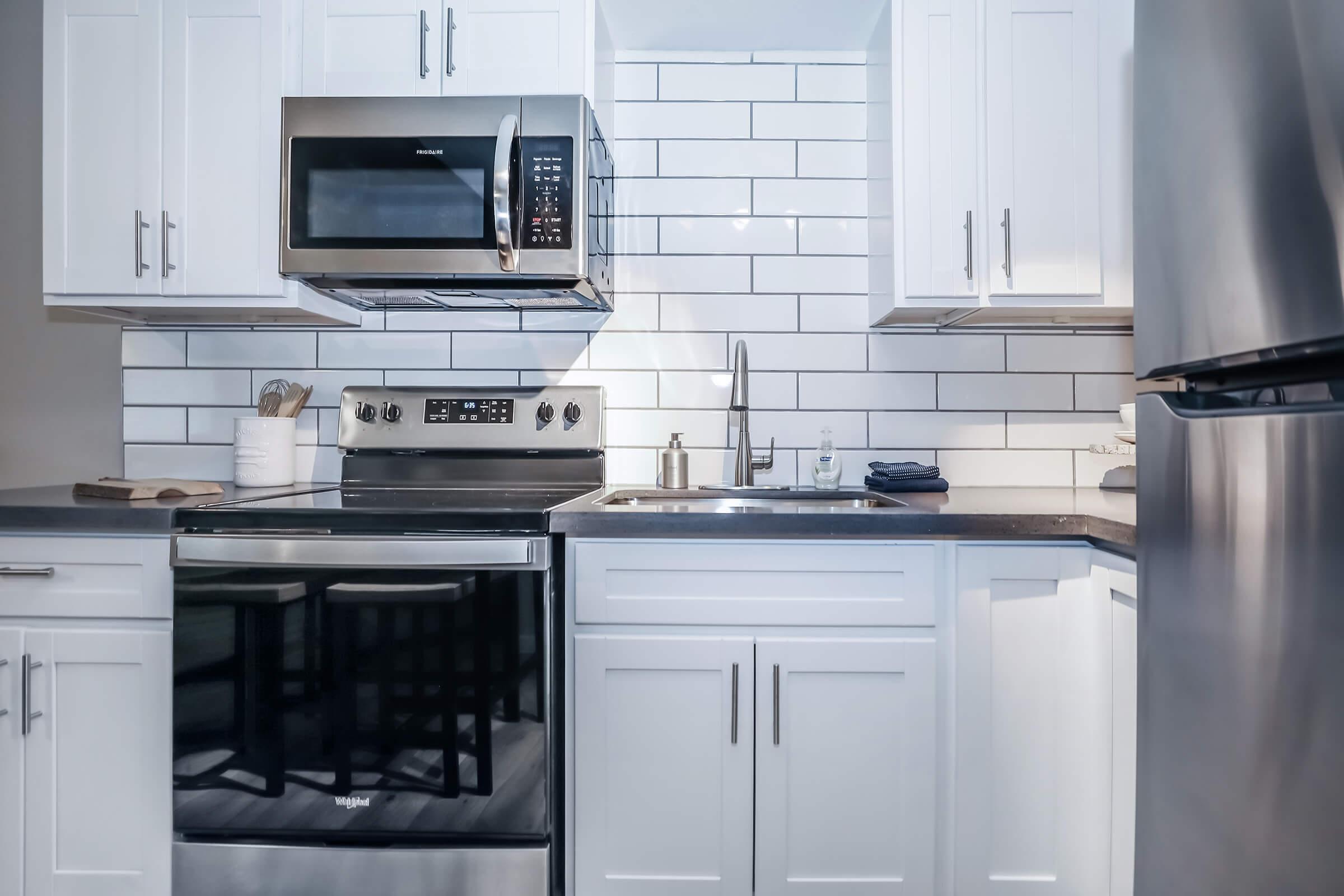 a stove top oven sitting inside of a kitchen