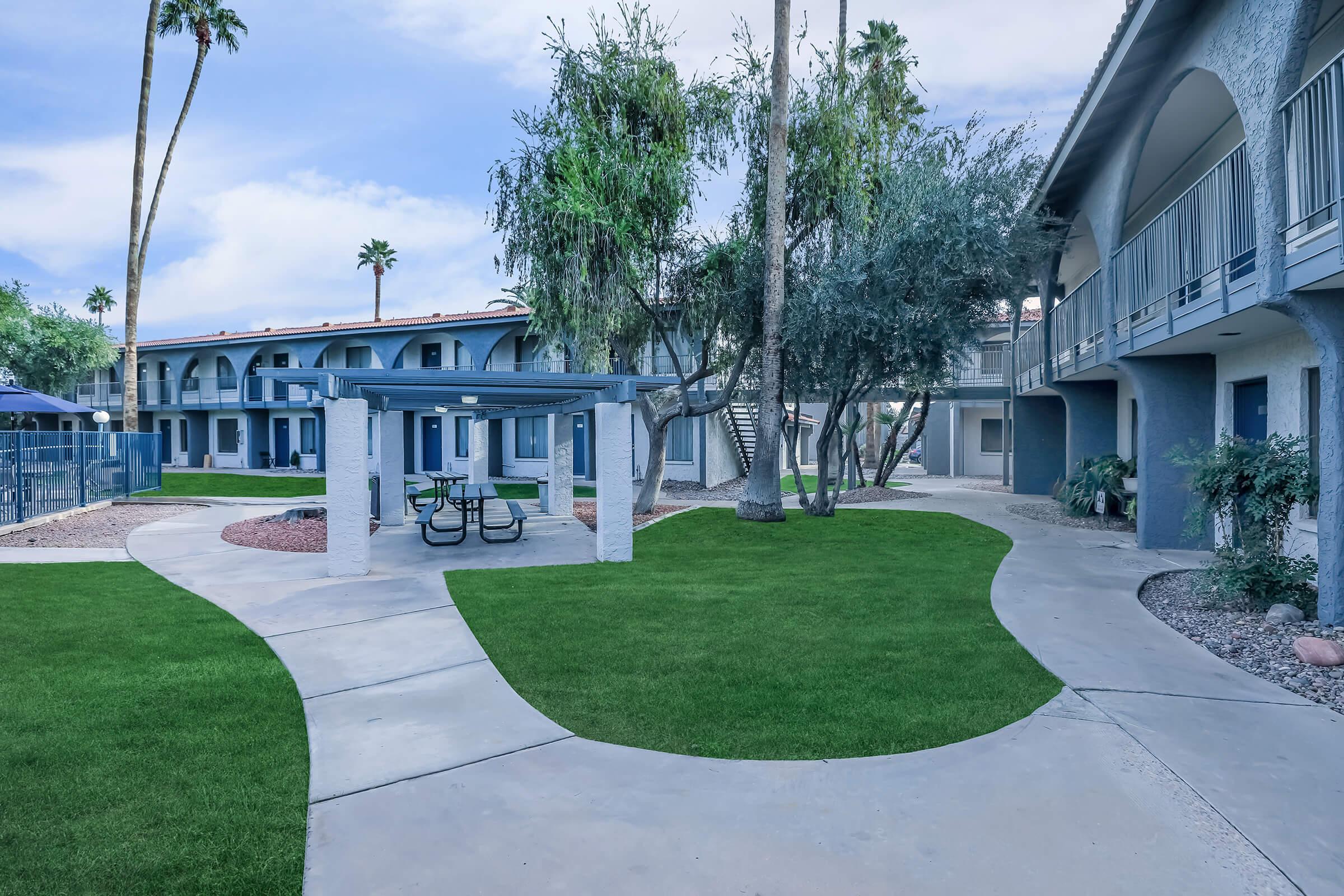 Outdoor sidewalk walkway leading up to a large apartment complex