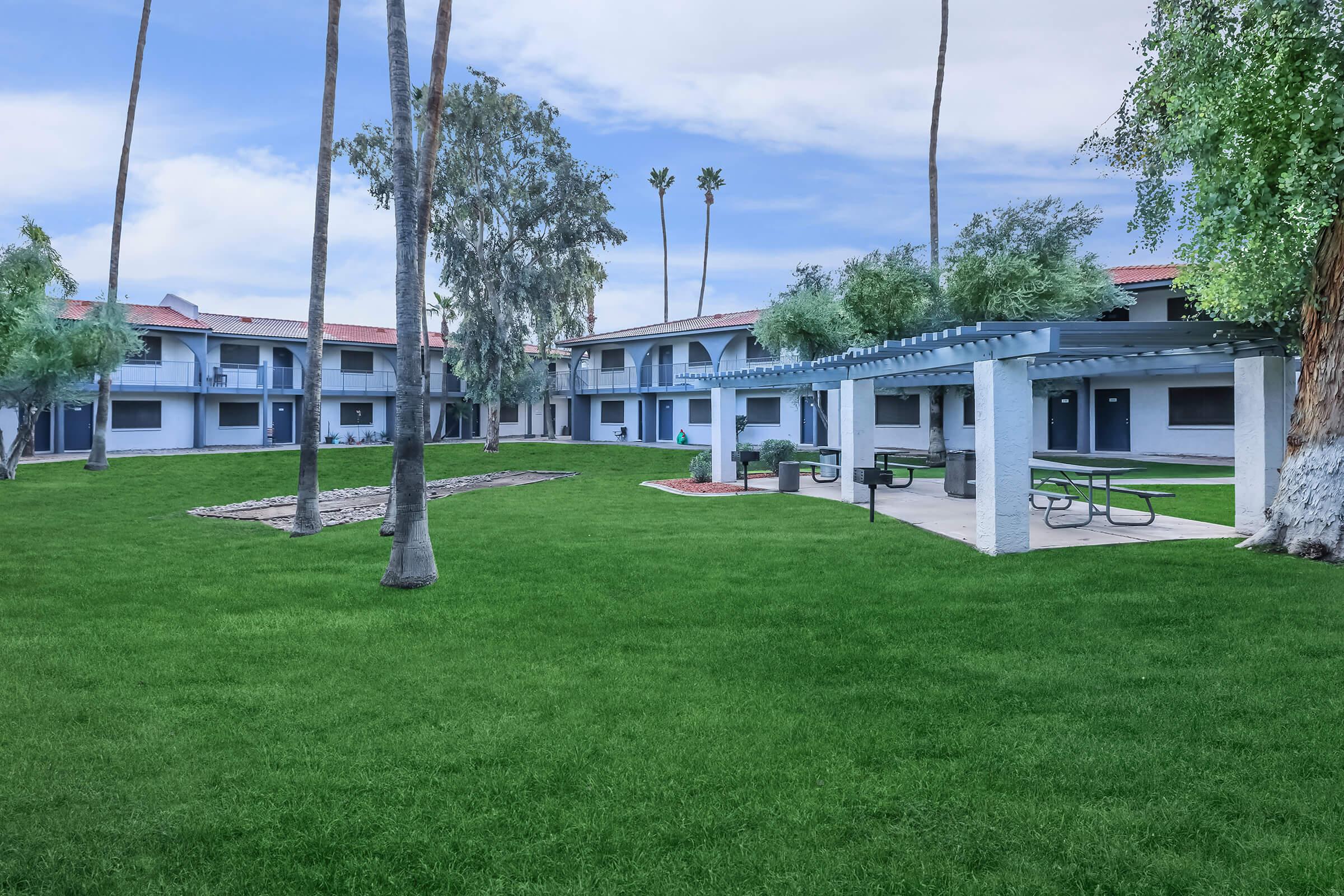 Apartment complex grass courtyard with seating area