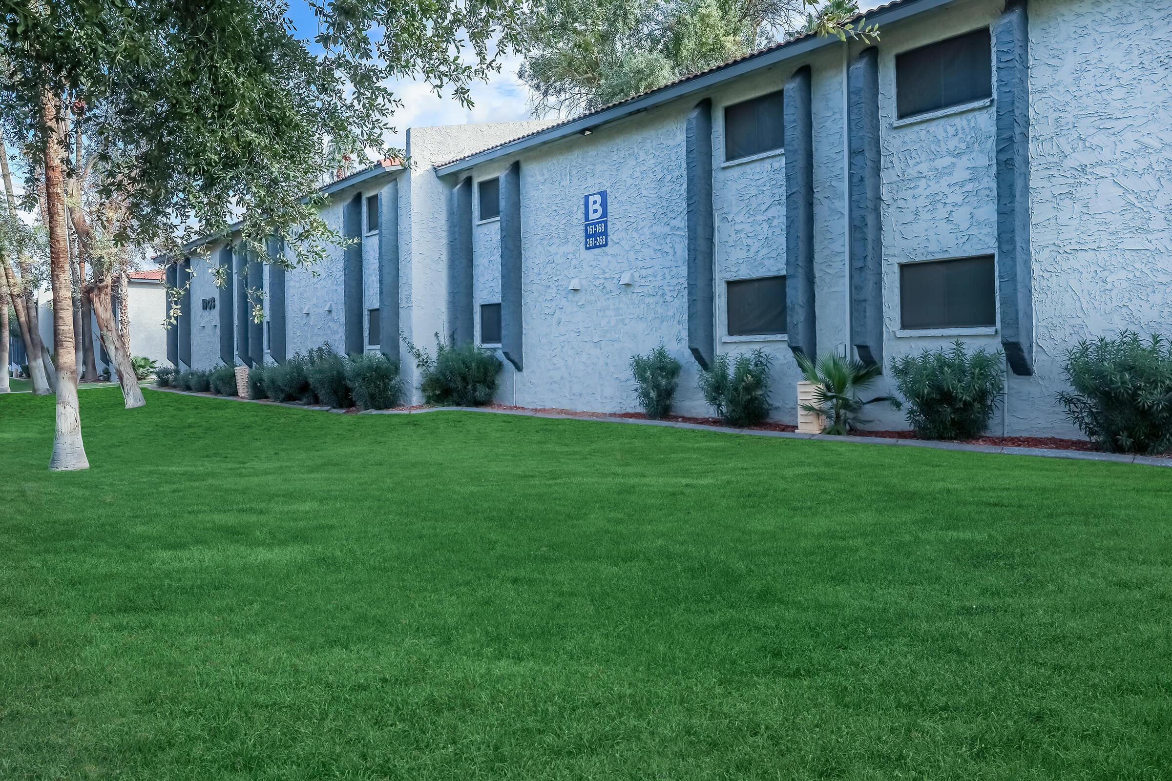 Exterior apartment building next to a large lot of grass