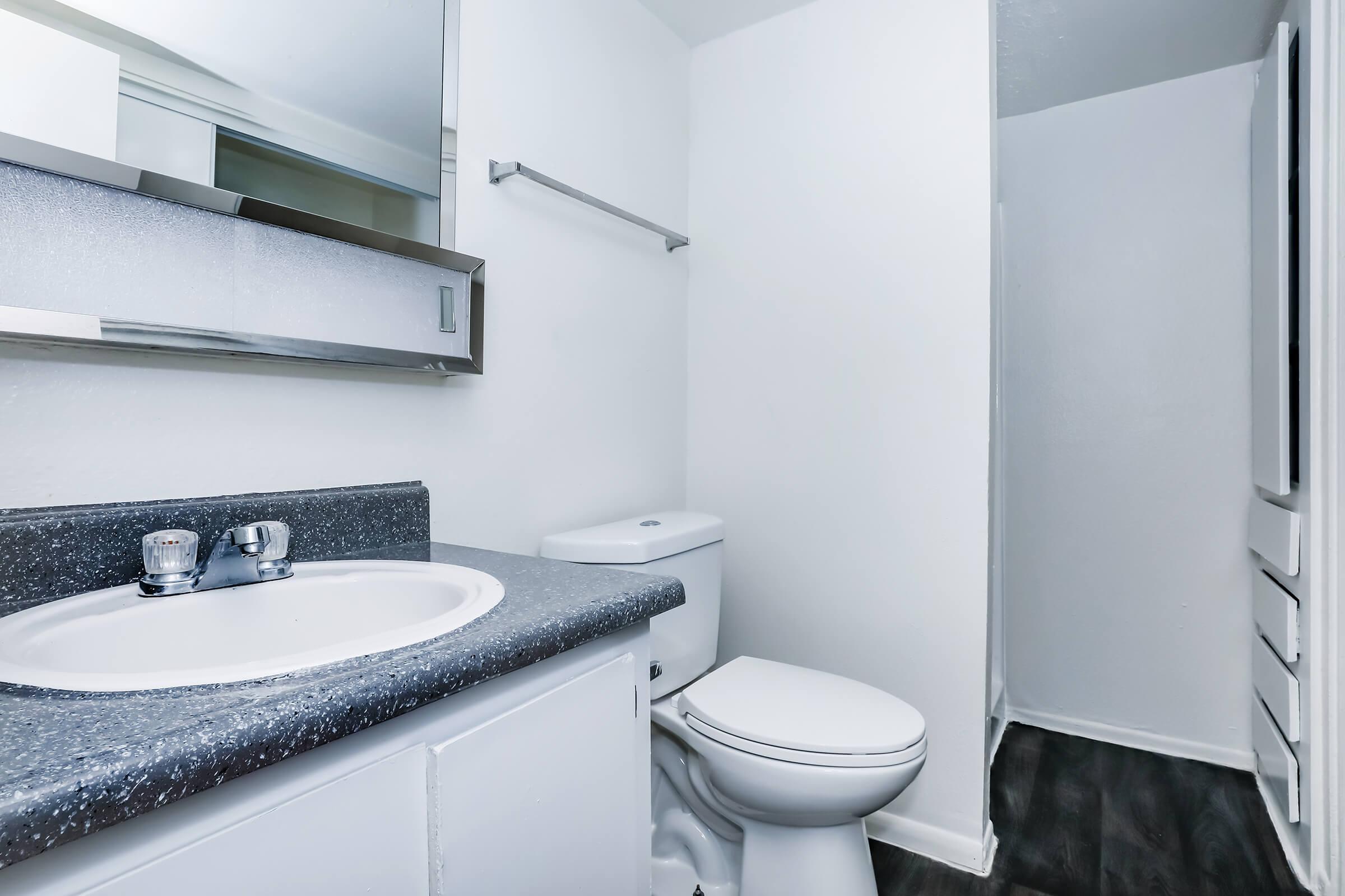 a kitchen with a sink and a mirror