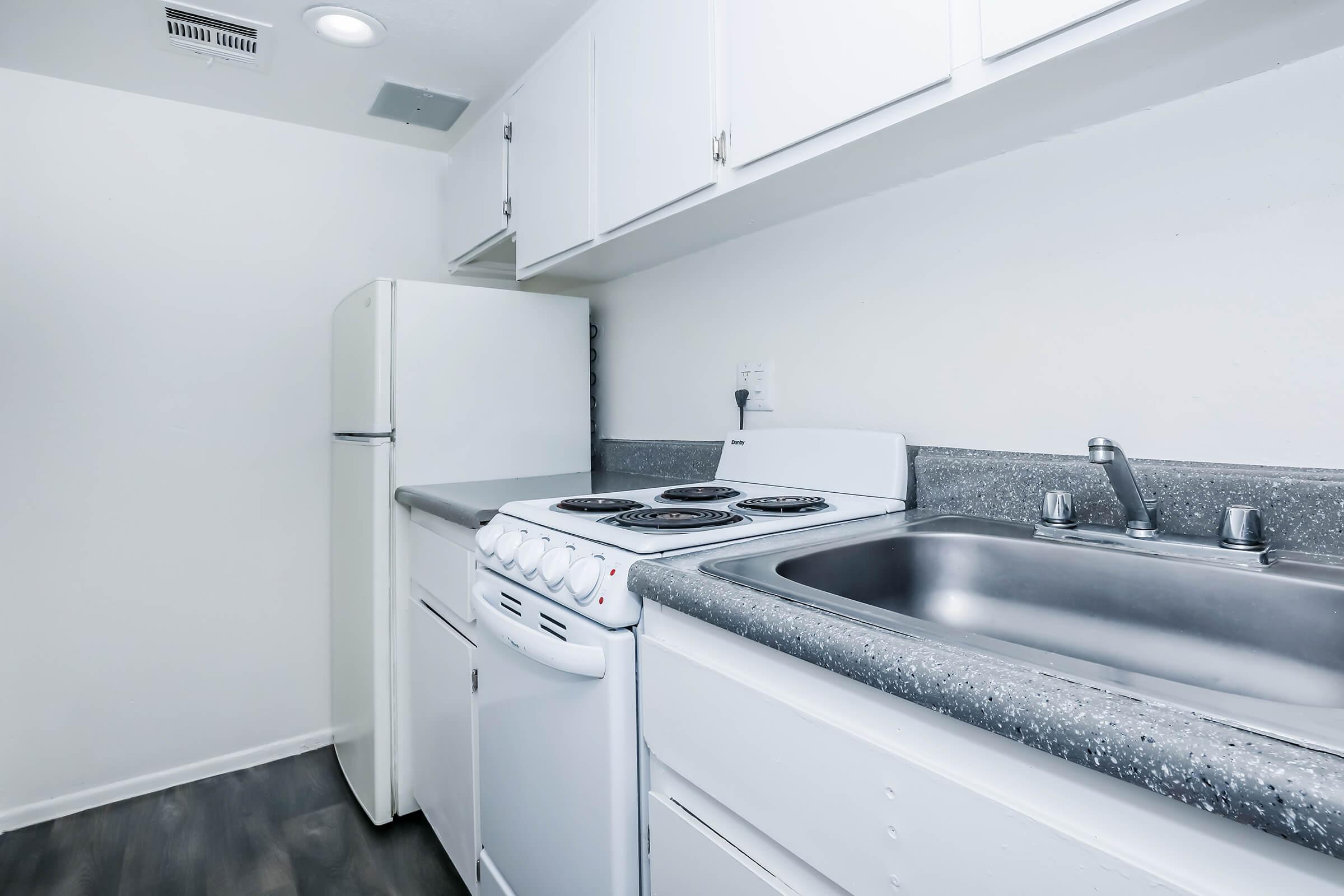 a kitchen with a stove and a refrigerator