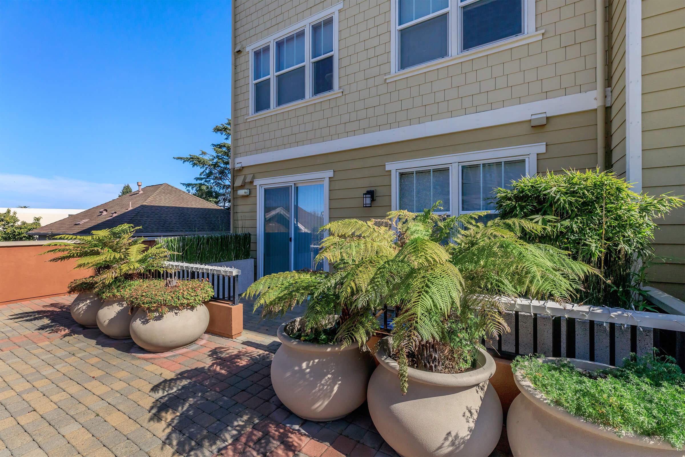 a garden in front of a brick building