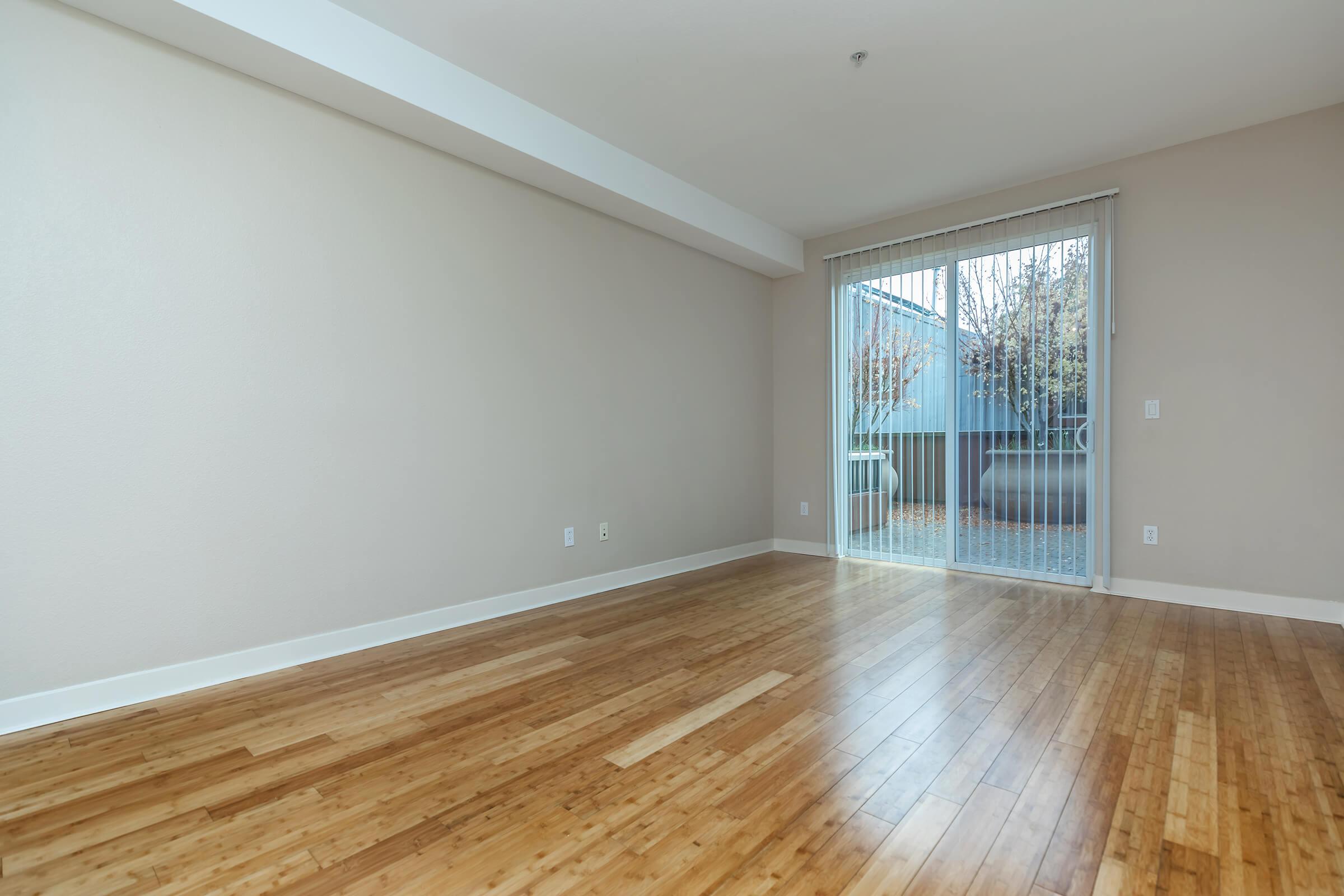 a view of a hard wood floor next to a window