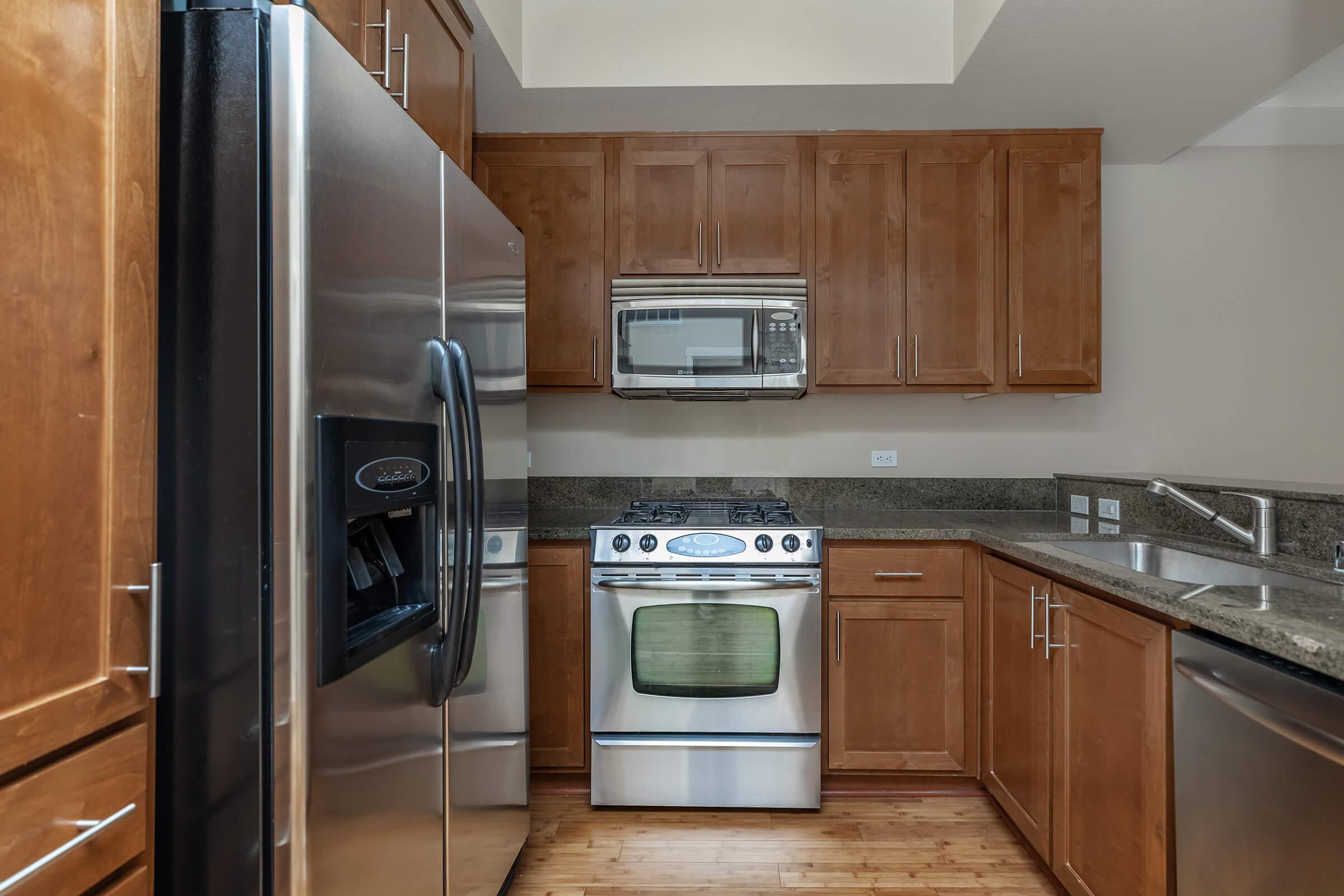 a kitchen with stainless steel appliances and wooden cabinets