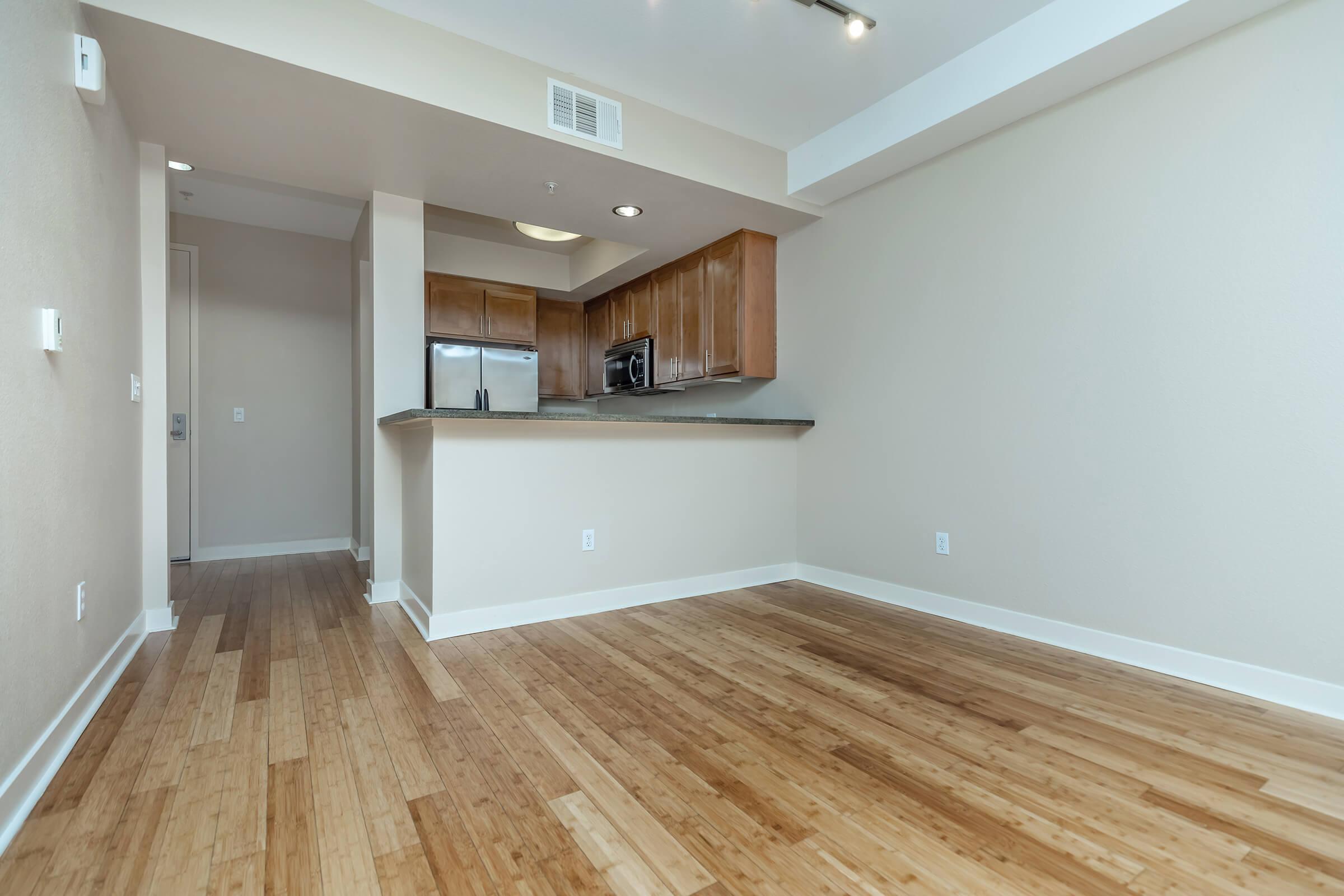 a large empty room with a wooden floor