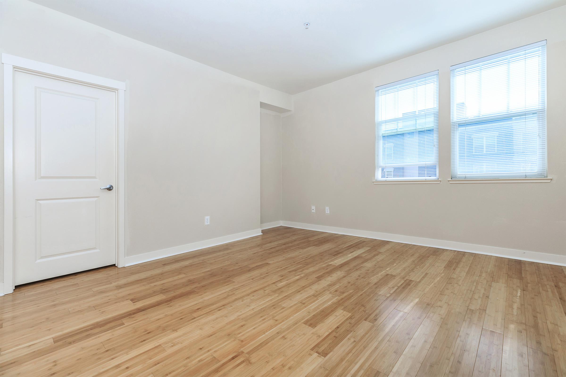 a view of a hard wood floor next to a window