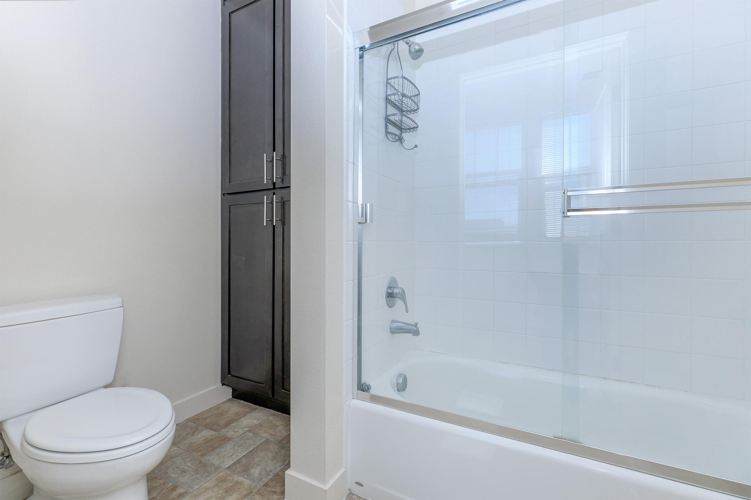 a large white tub sitting next to a shower