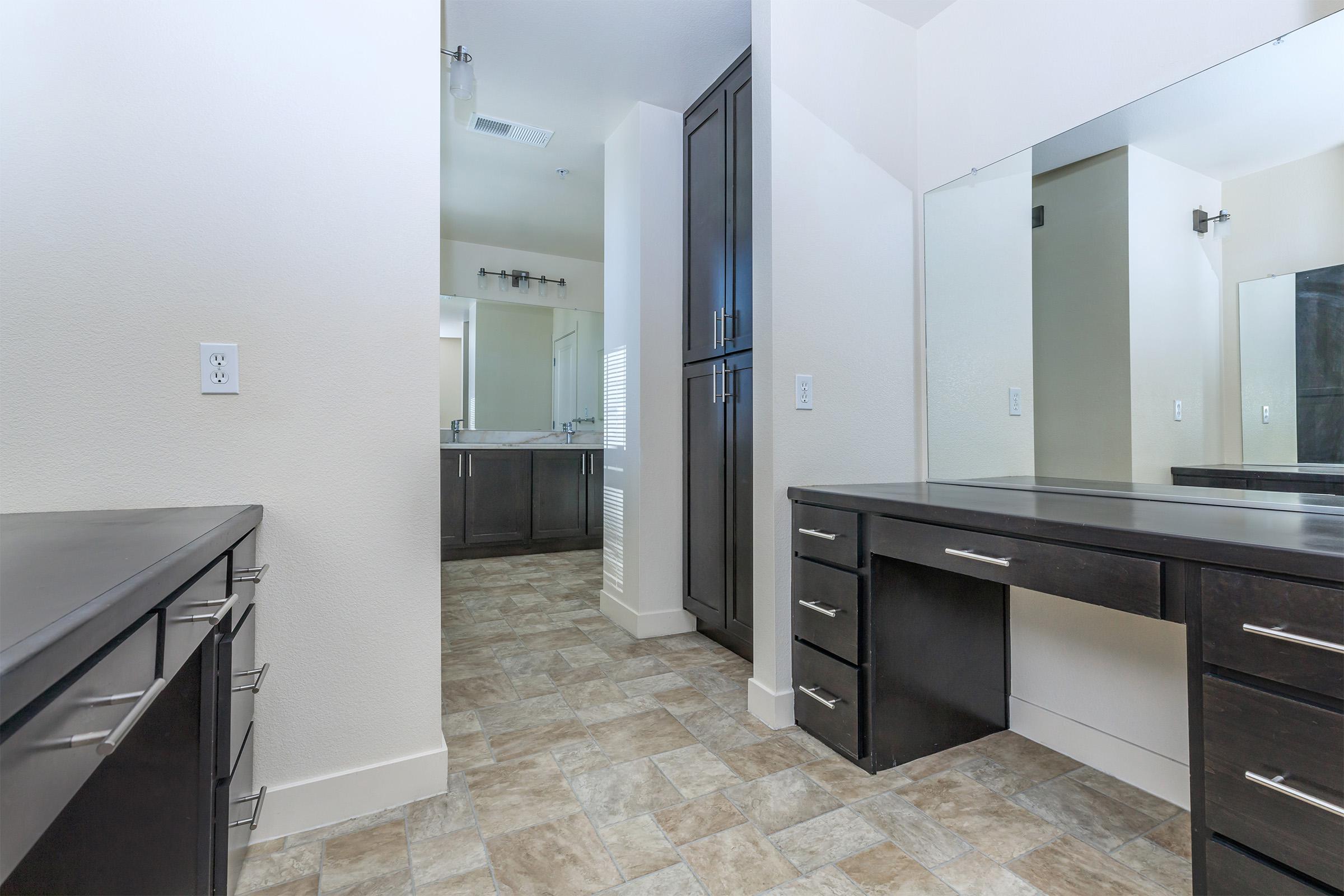 a kitchen with a sink and a mirror