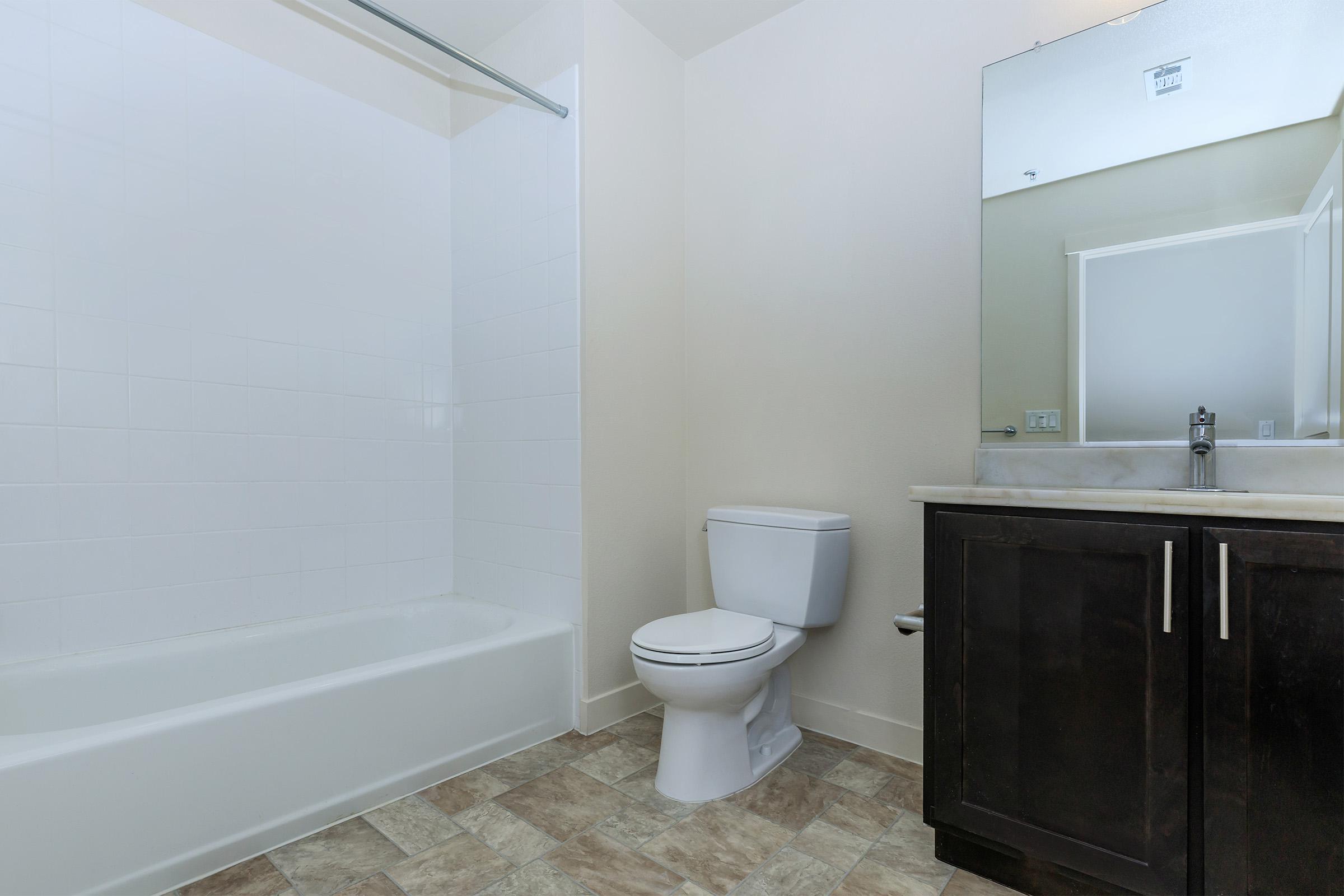 a white tub sitting next to a sink