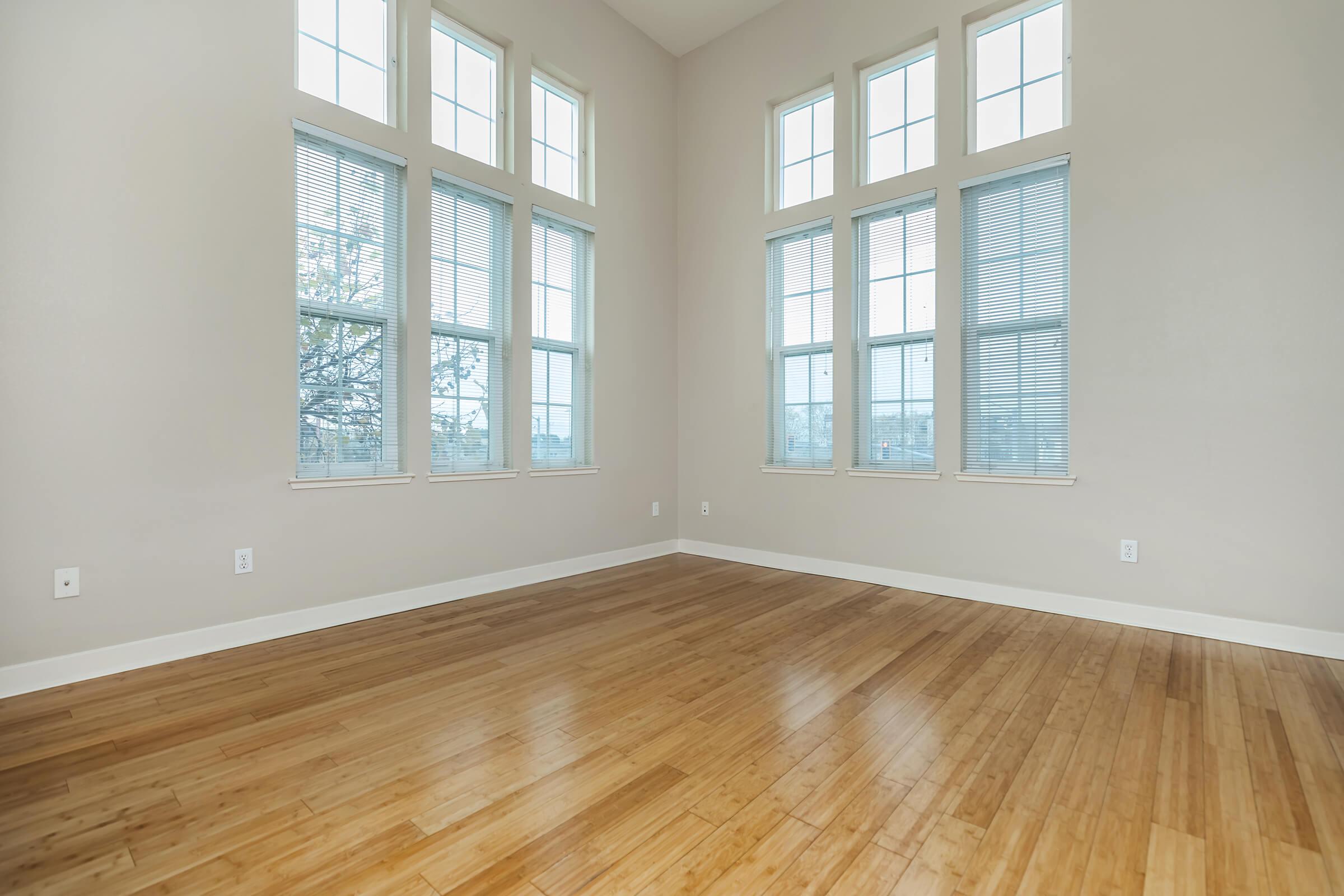 a close up of a hard wood floor next to a window