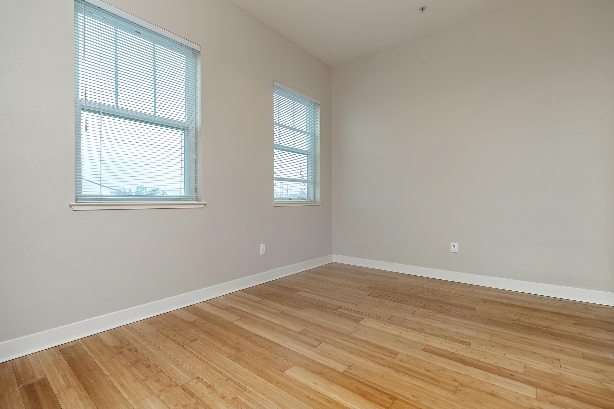 a close up of a hard wood floor next to a window