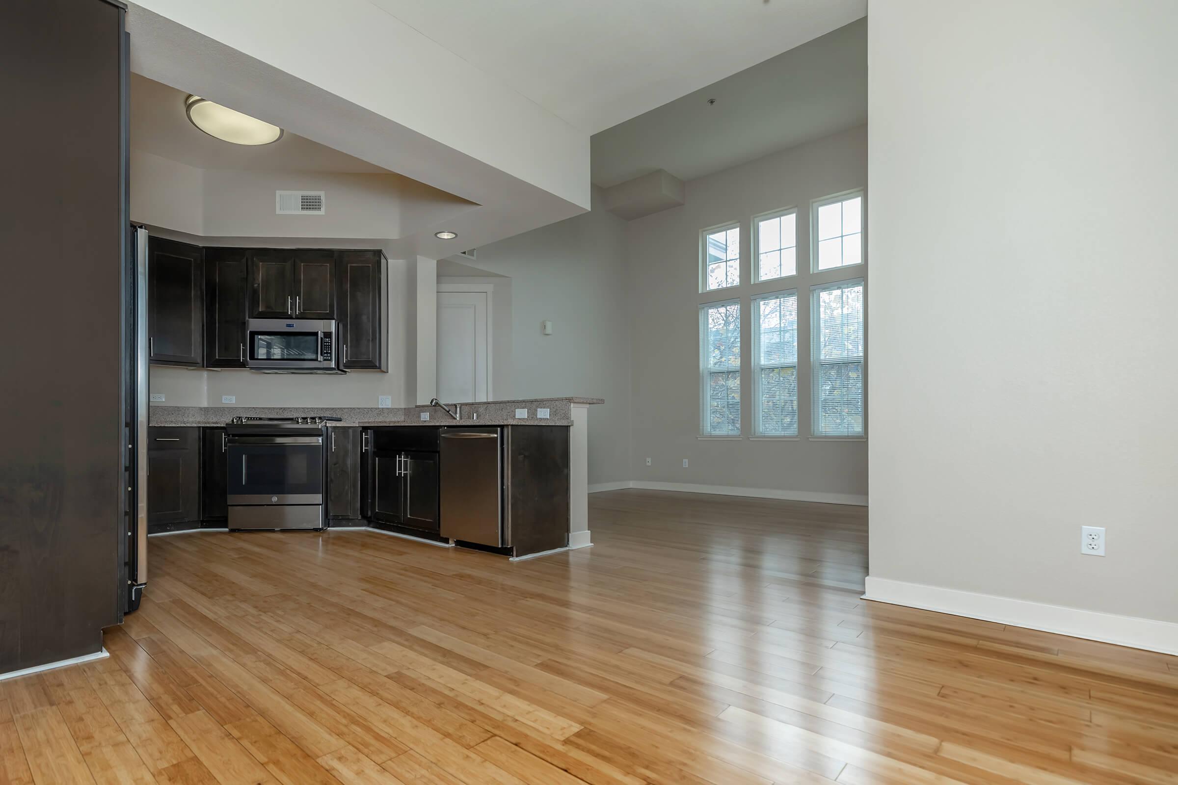 a large kitchen with stainless steel appliances and wooden cabinets