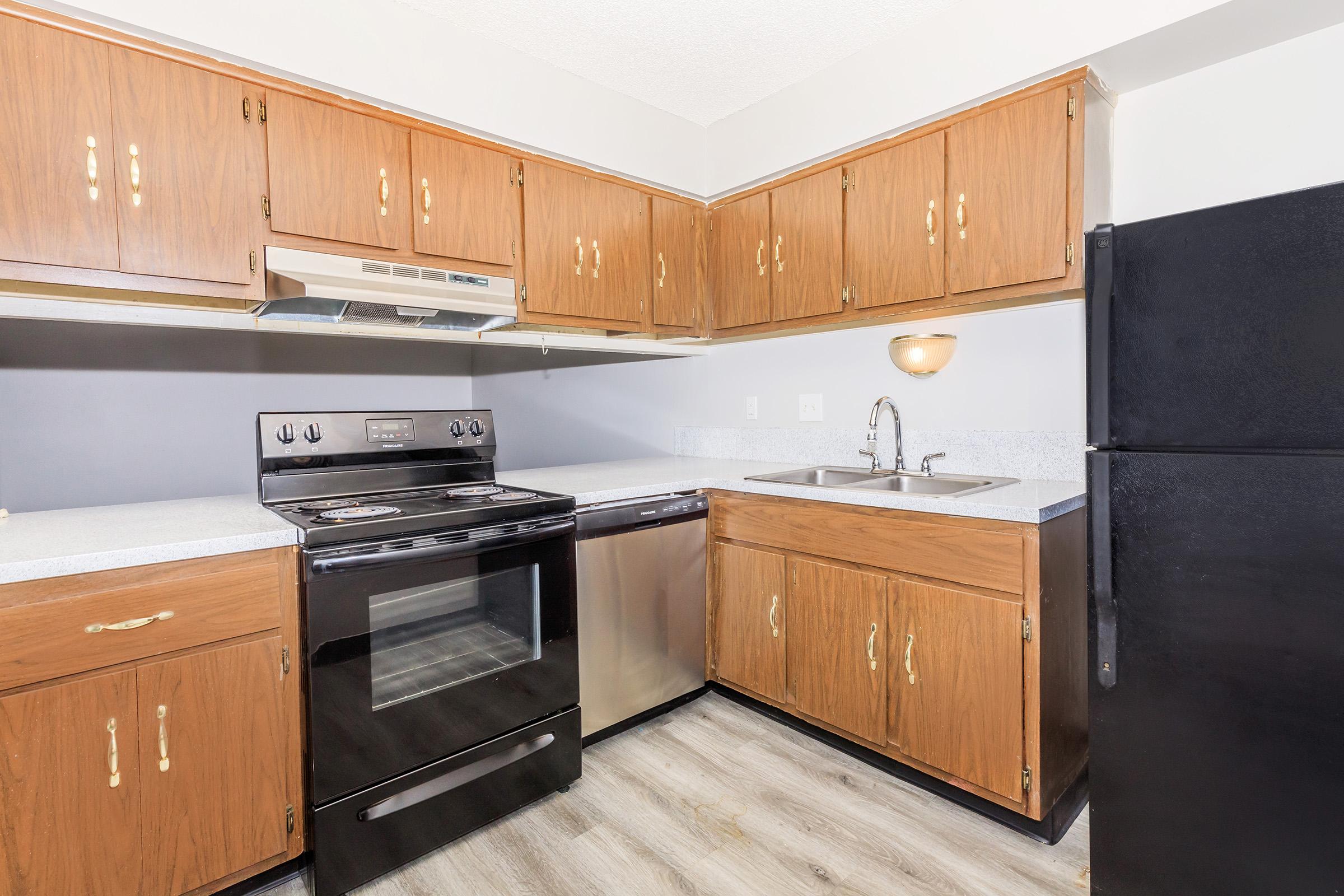 a kitchen with a stove and a refrigerator