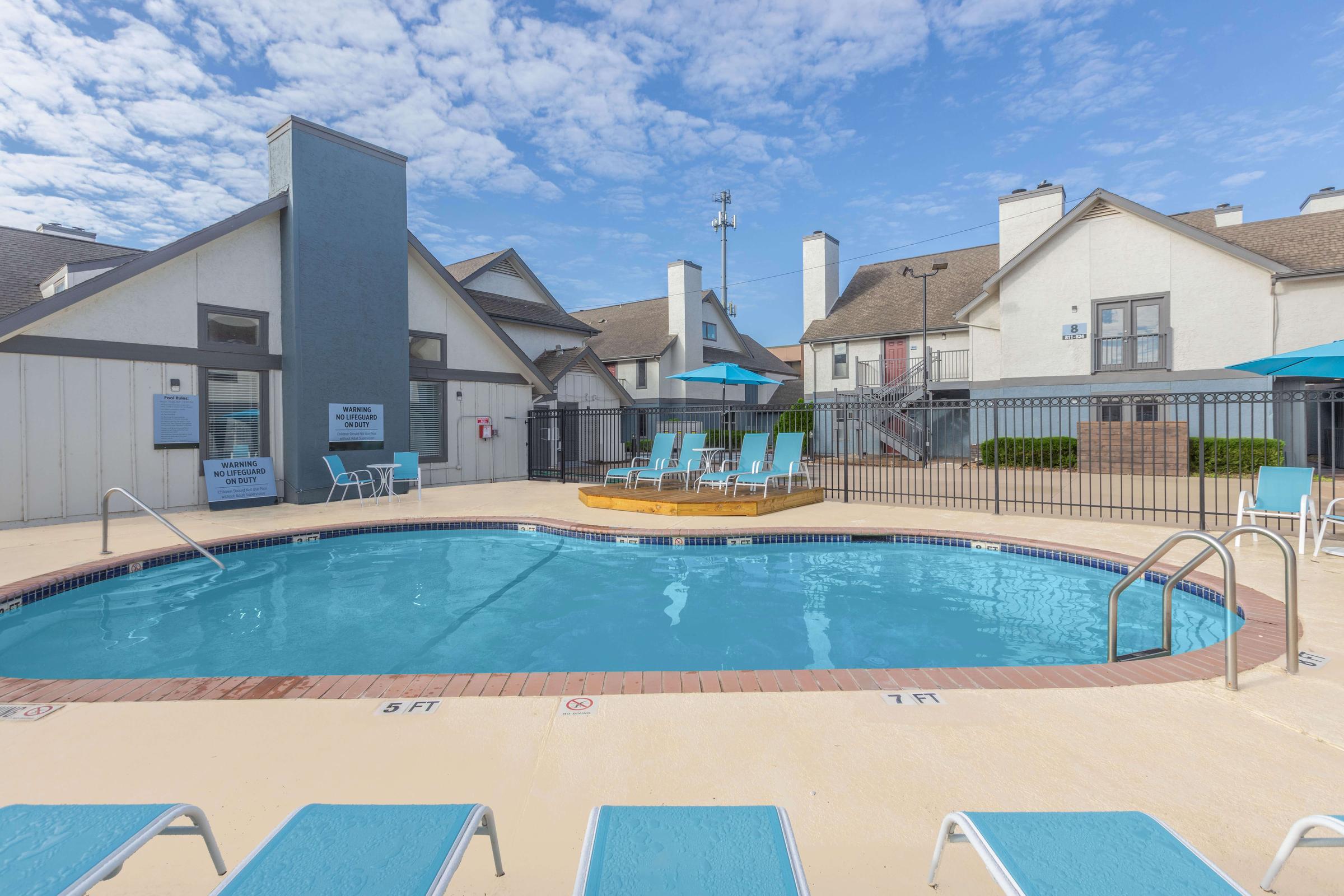 a house with a pool in front of a building