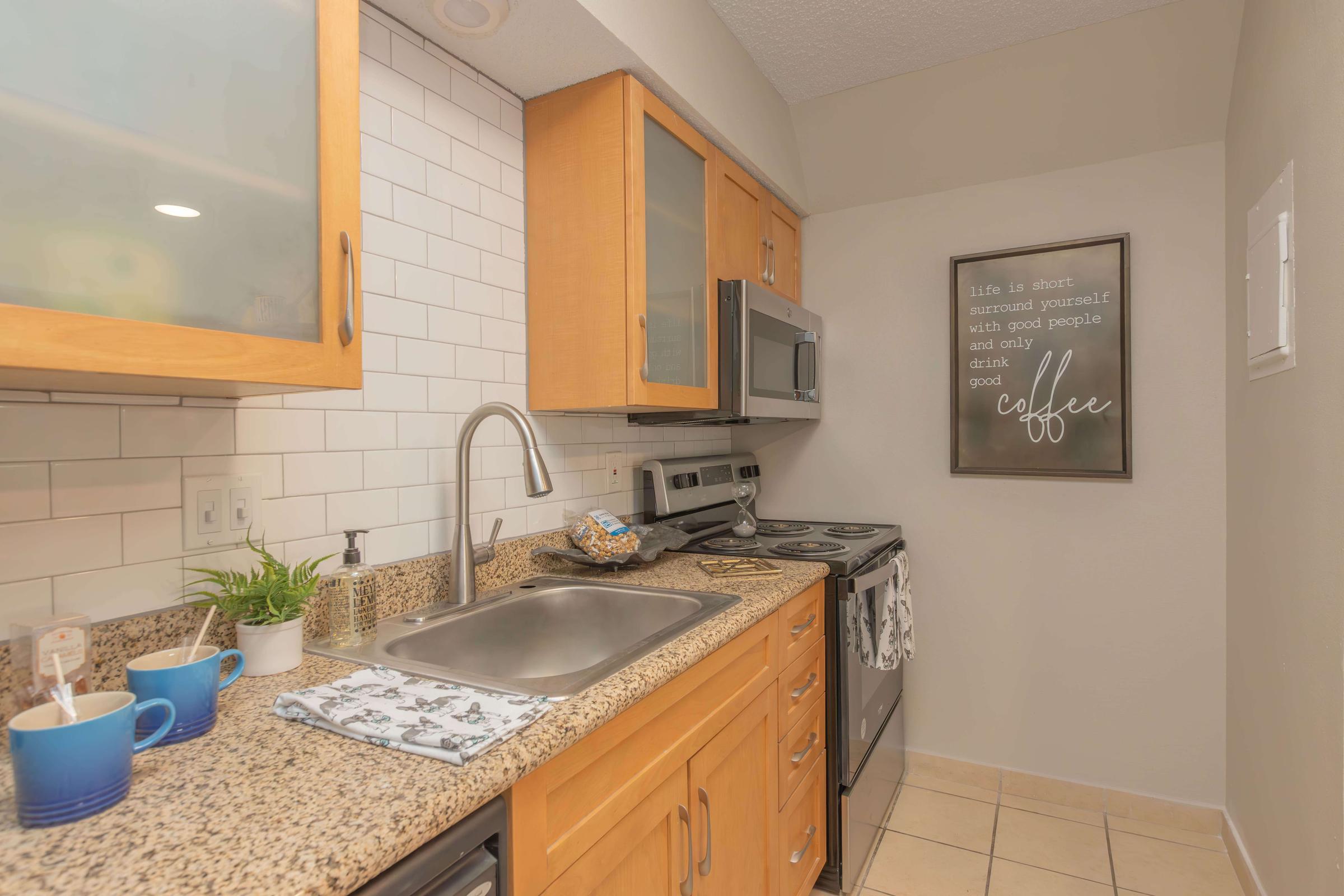 a kitchen with a sink and a microwave