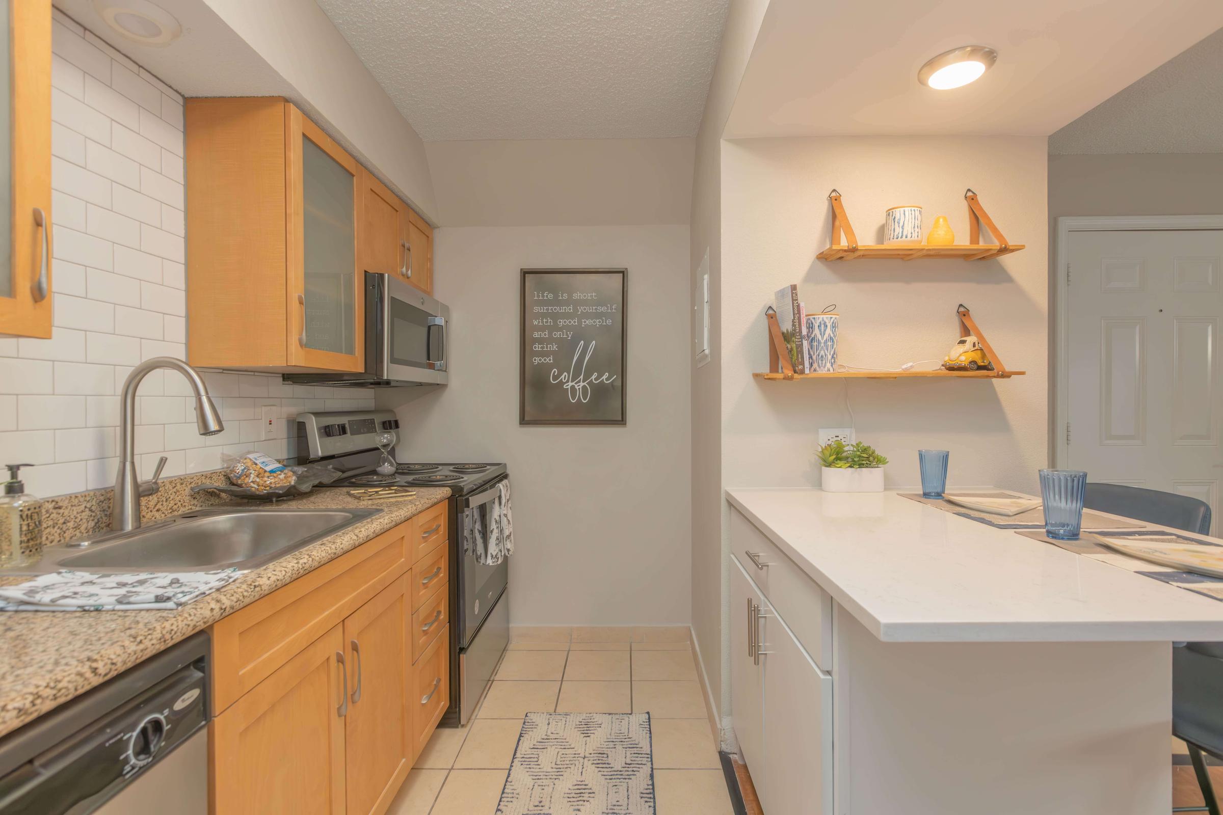 a kitchen with a sink and a microwave