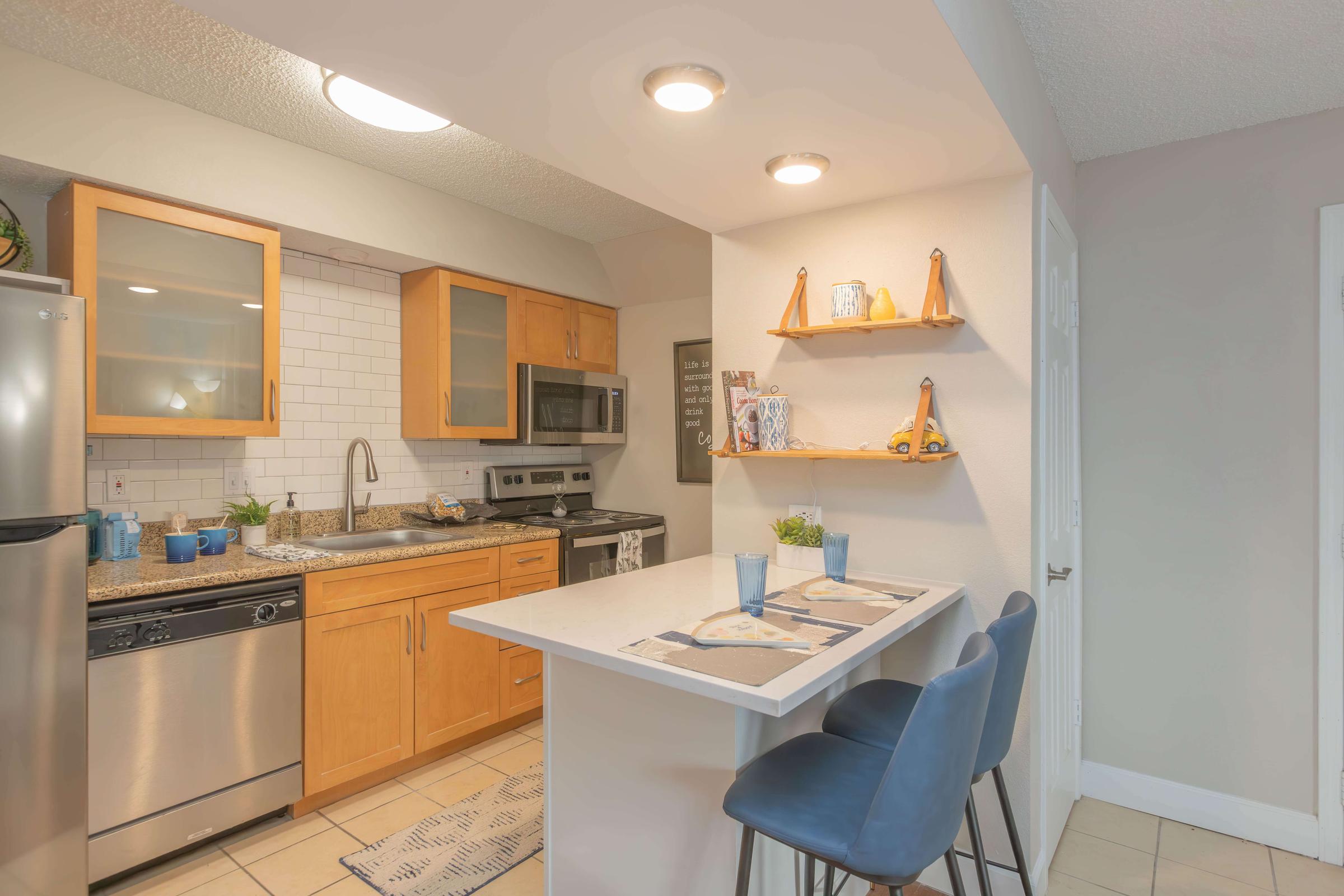 a kitchen with an island in the middle of a room