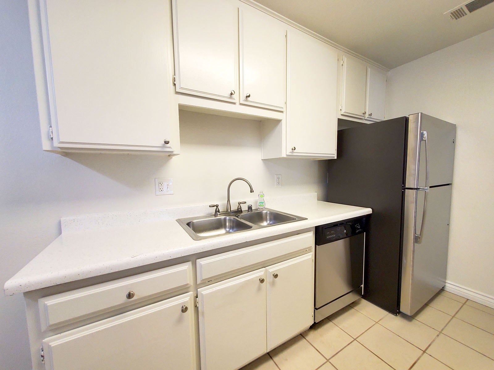 a kitchen with a sink and a refrigerator