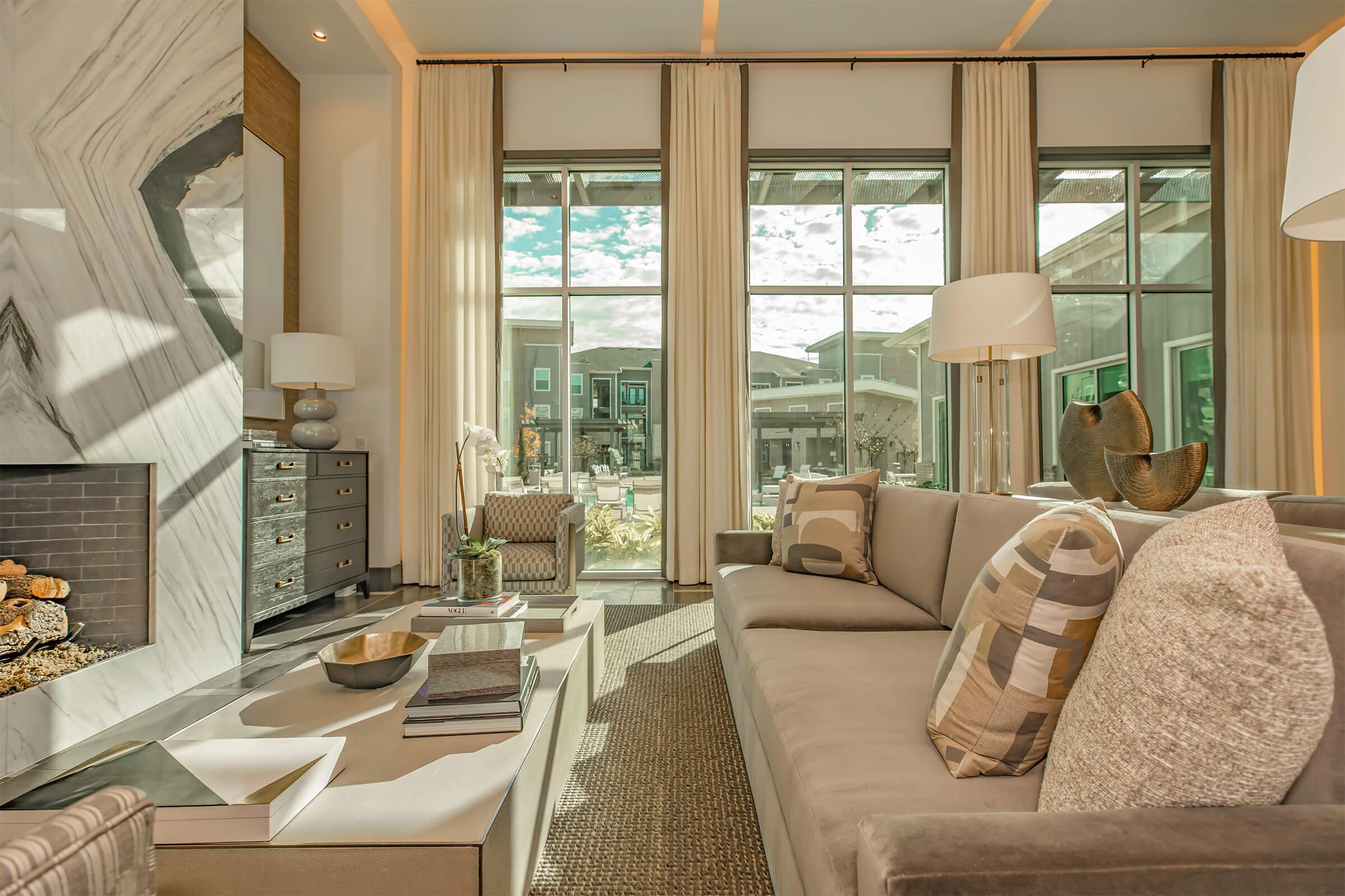 a living room filled with furniture and a large window