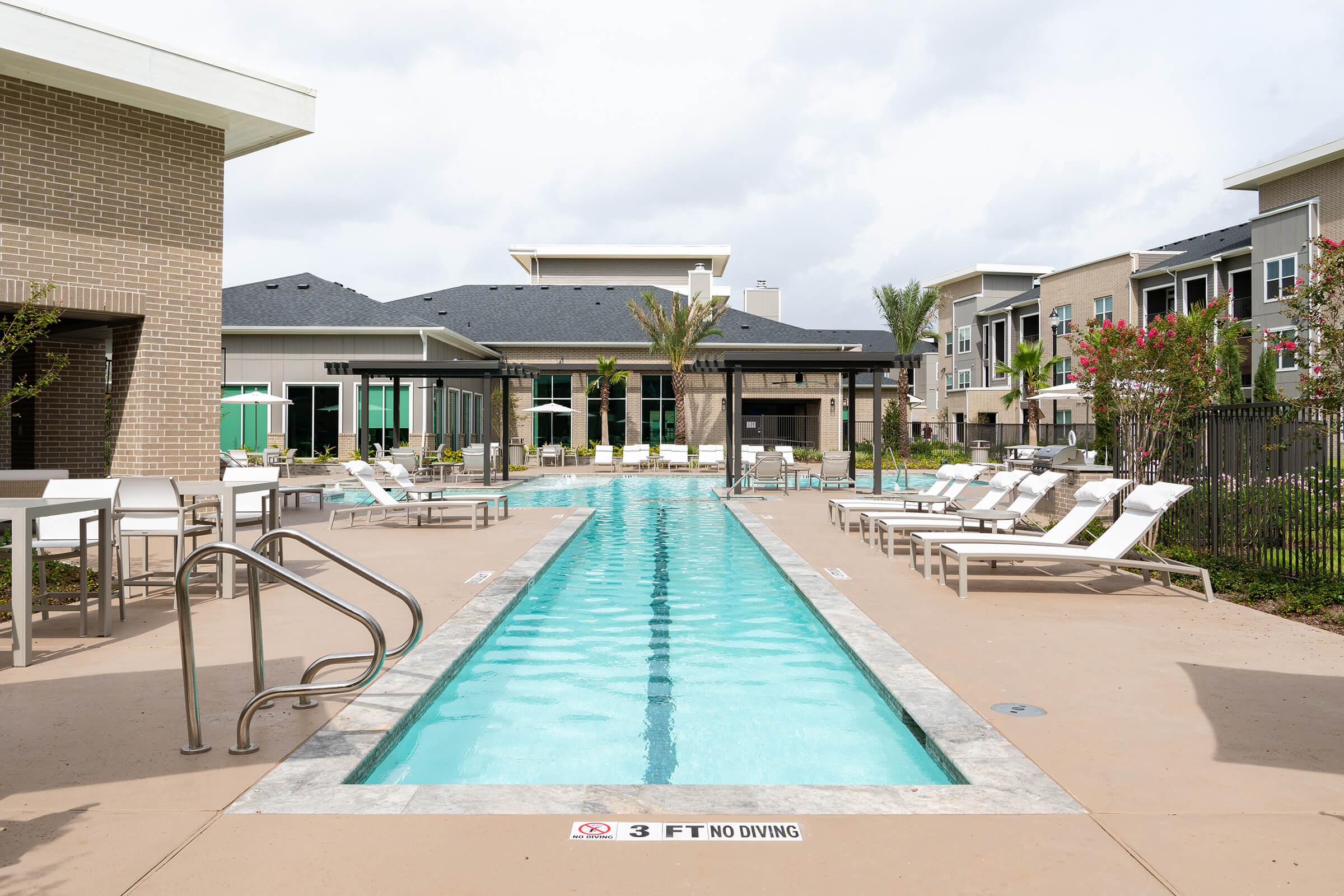 a house with a pool in front of a building