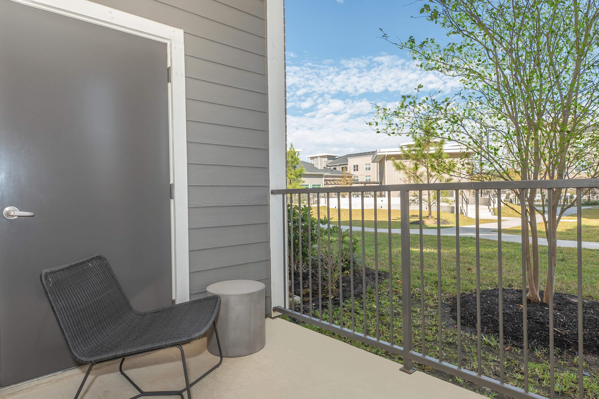 a chair sitting in front of a fence