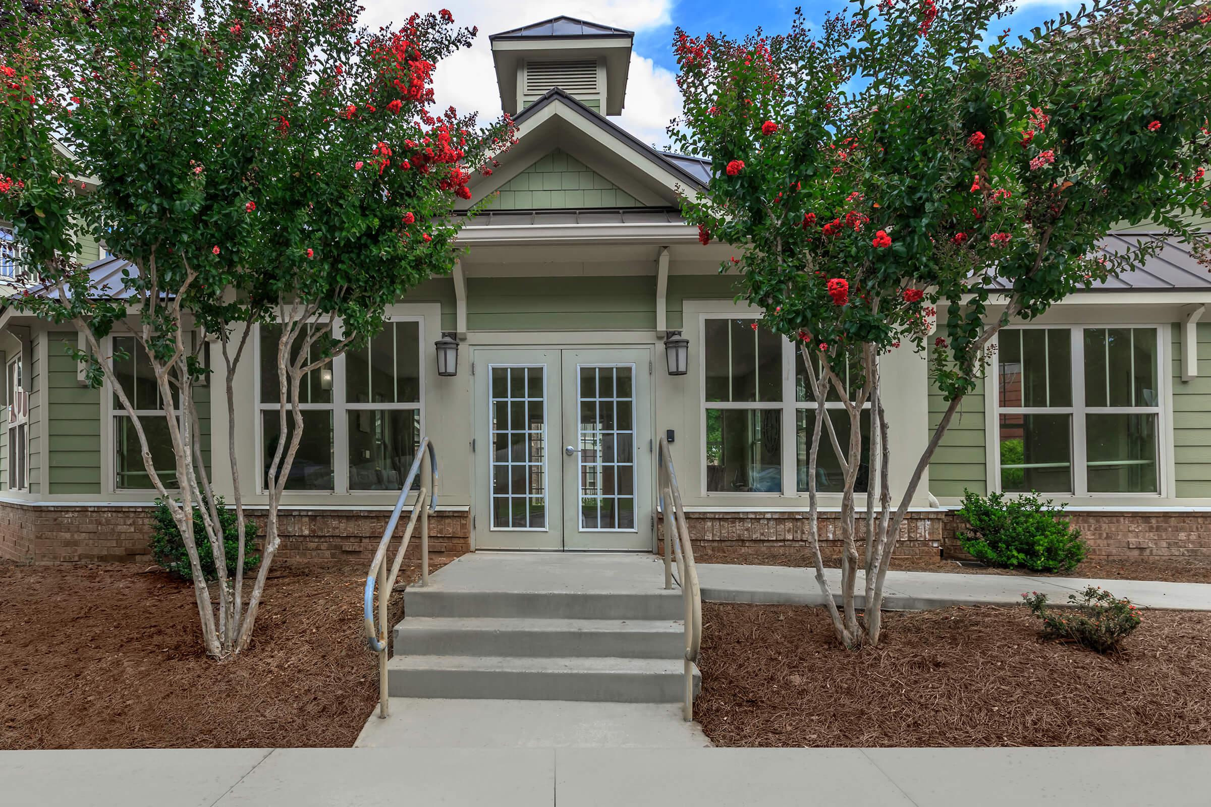 a house with bushes in front of a building