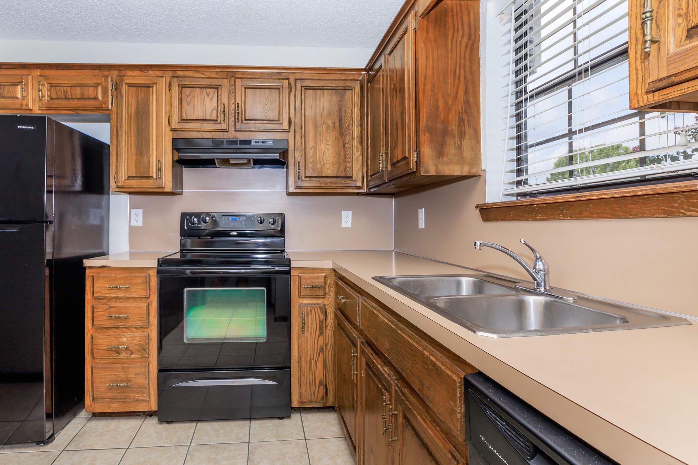 a stove top oven sitting inside of a kitchen