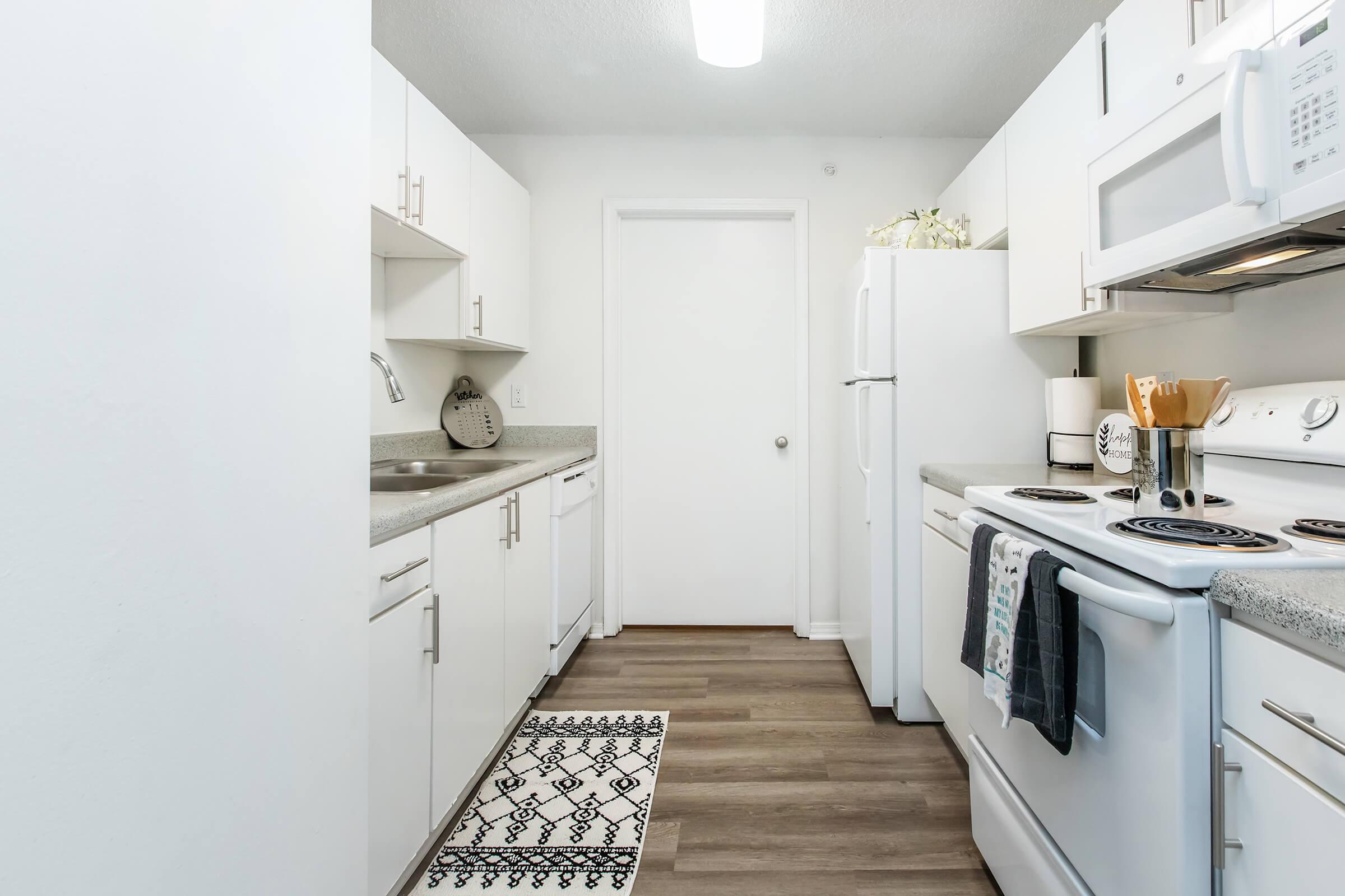 a kitchen with a stove sink and refrigerator