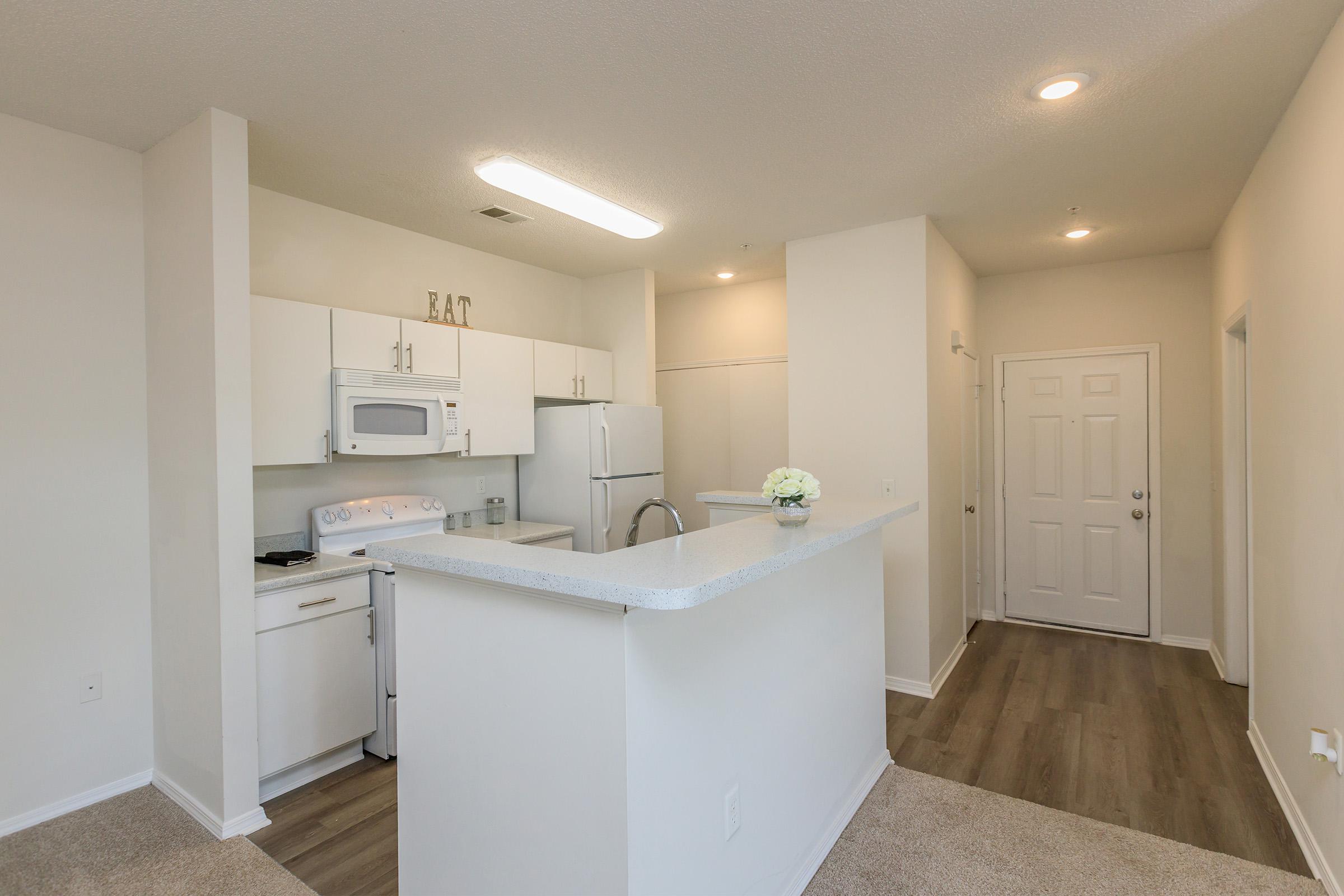 a kitchen with a sink and a refrigerator