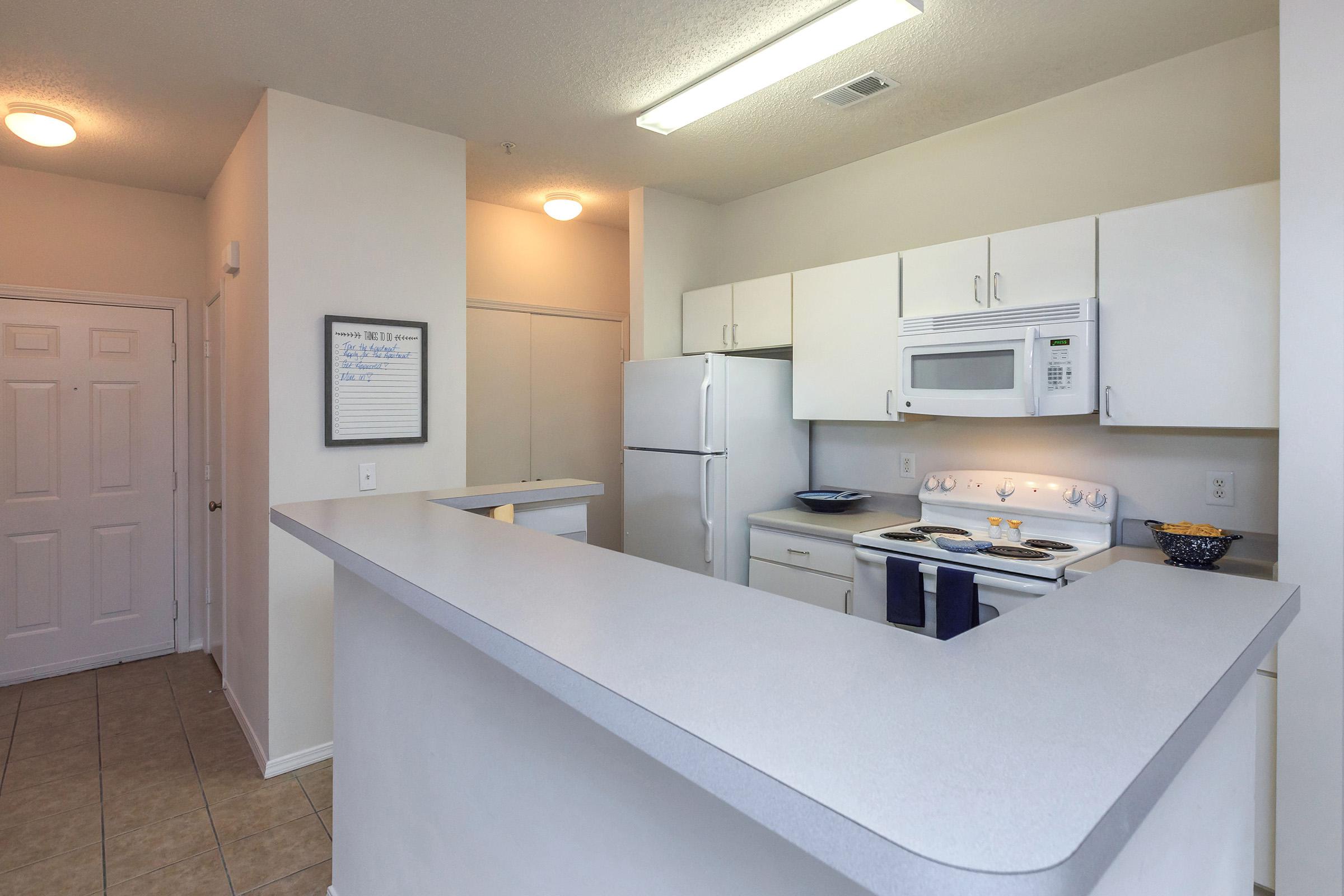 a kitchen with a sink and a refrigerator