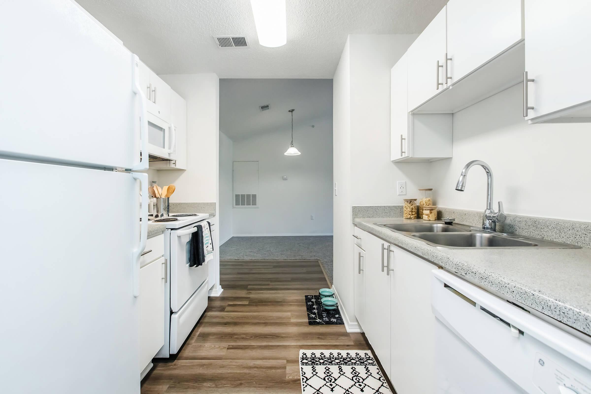 a kitchen with a sink and a refrigerator