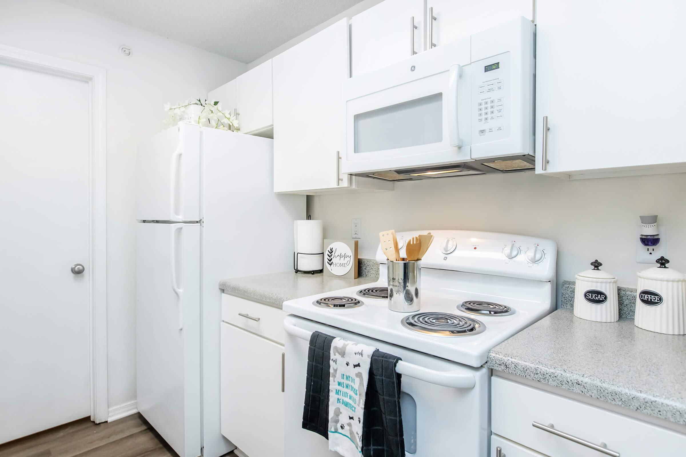 a kitchen with a sink and a mirror