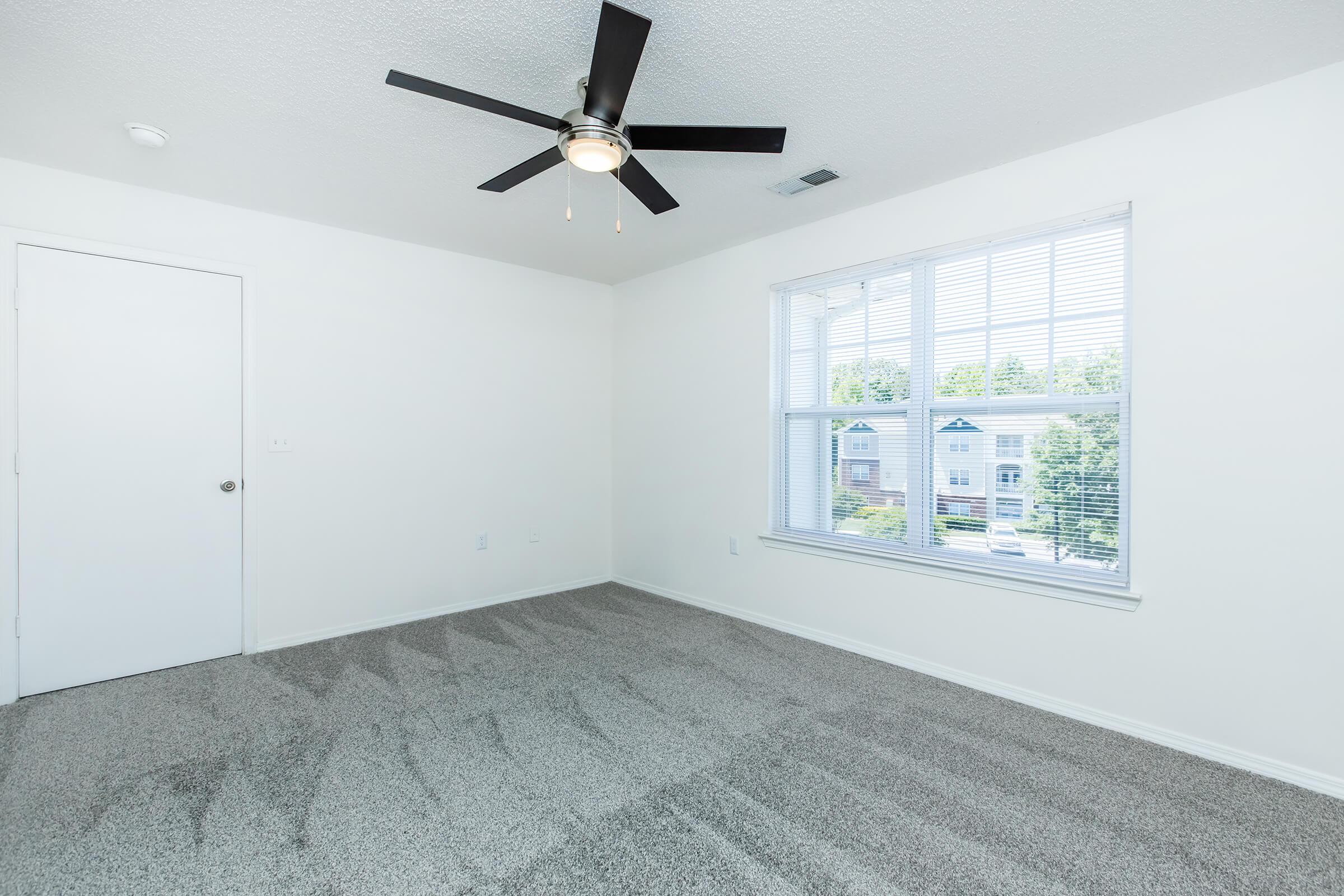 a bedroom with a large window