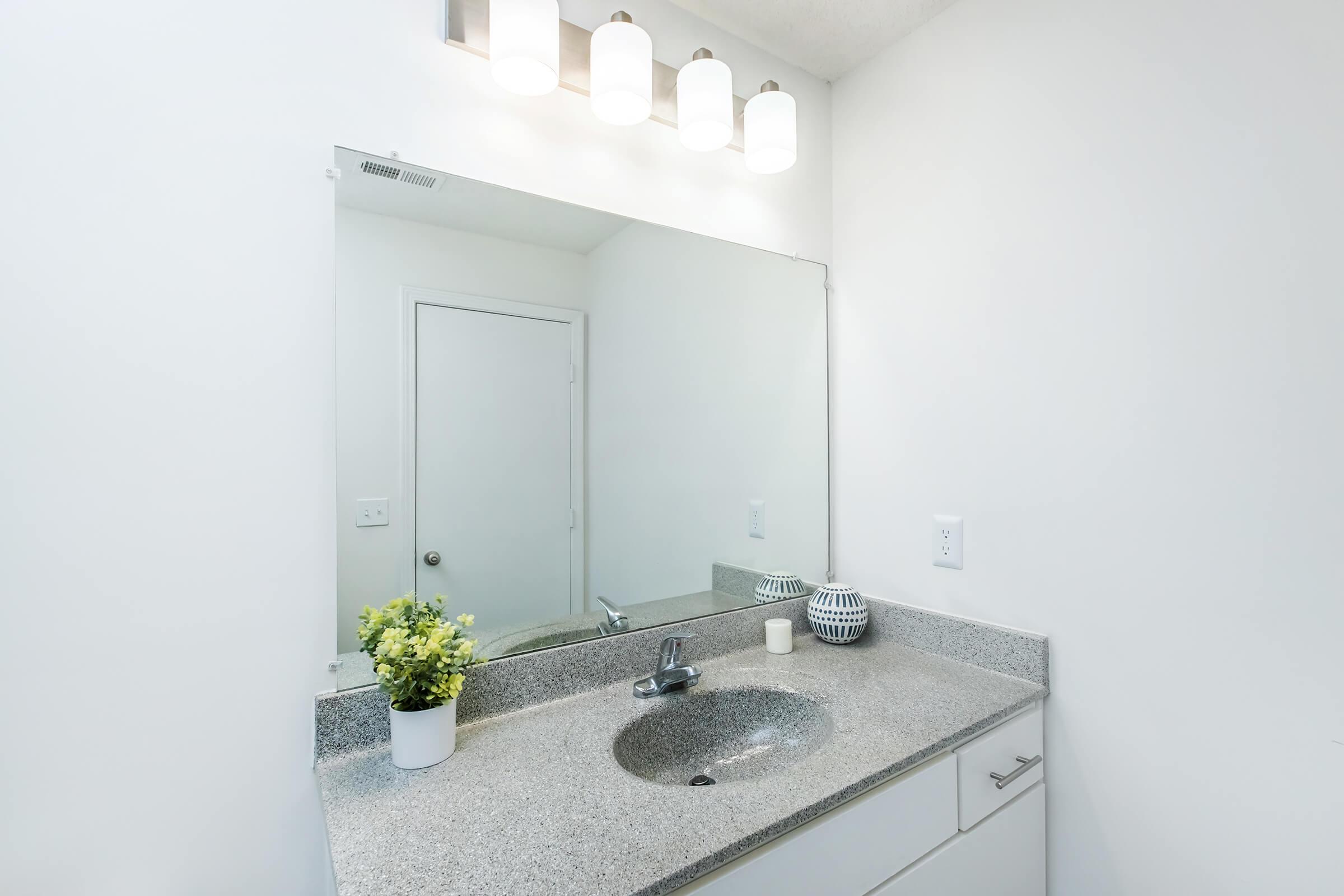 a kitchen with a sink and a mirror