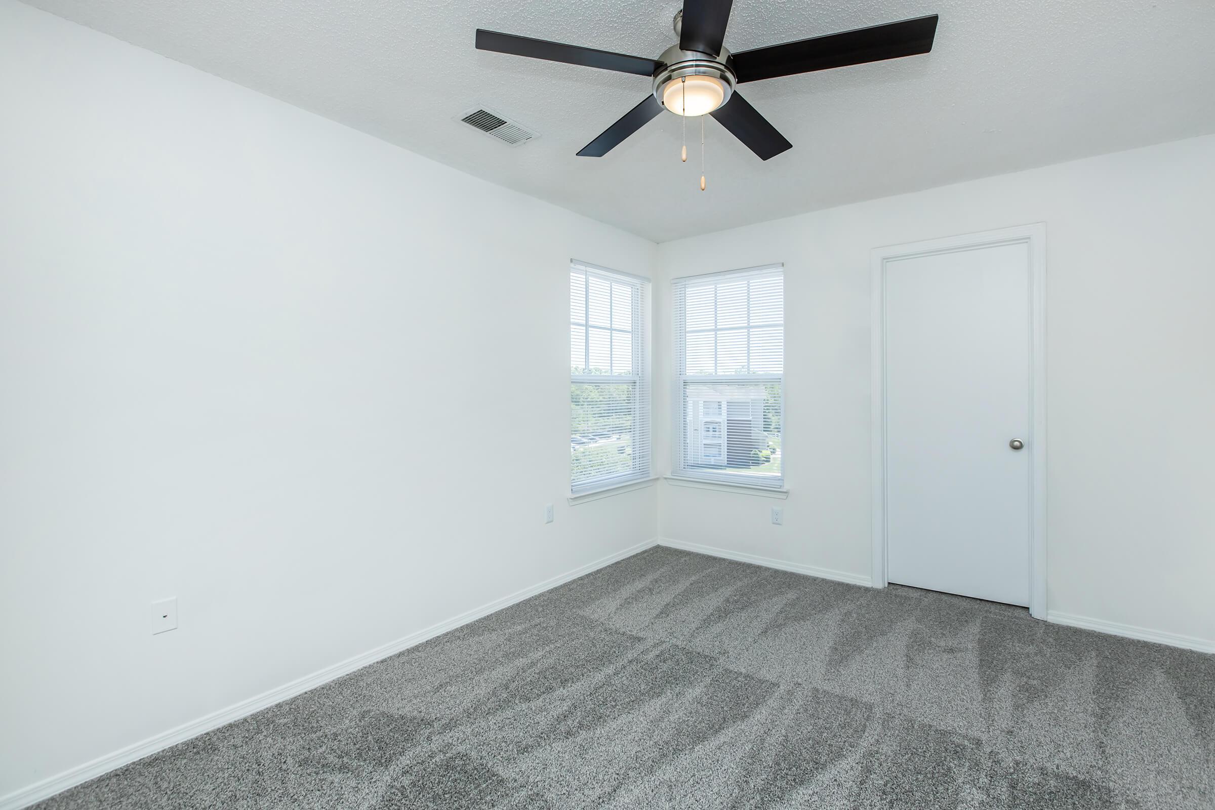 a bedroom with a clock in the middle of a room