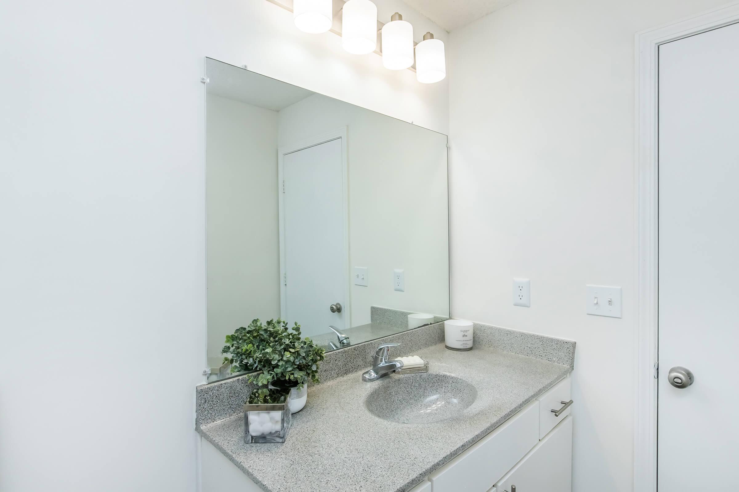 a kitchen with a sink and a mirror