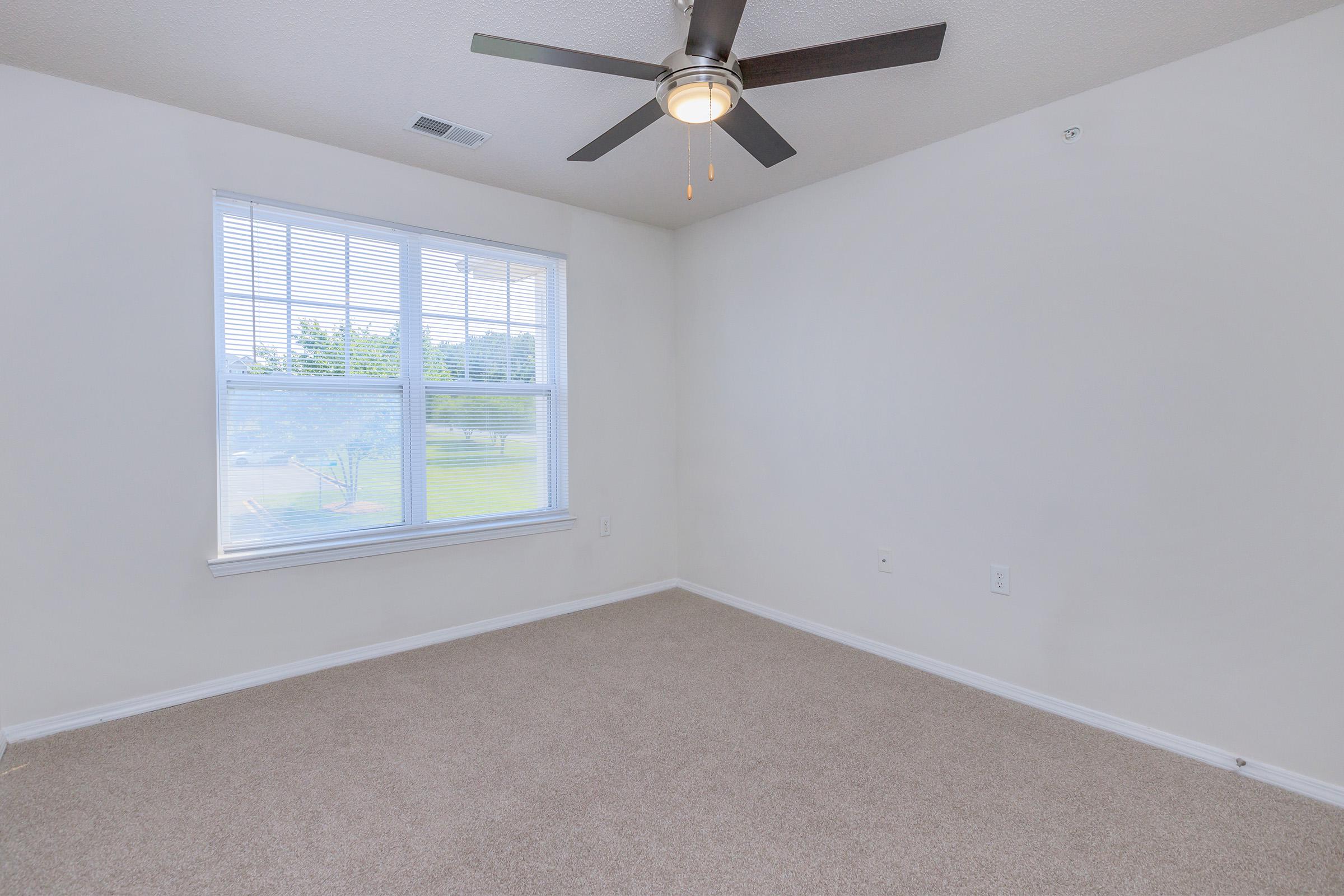 a bedroom with a large window