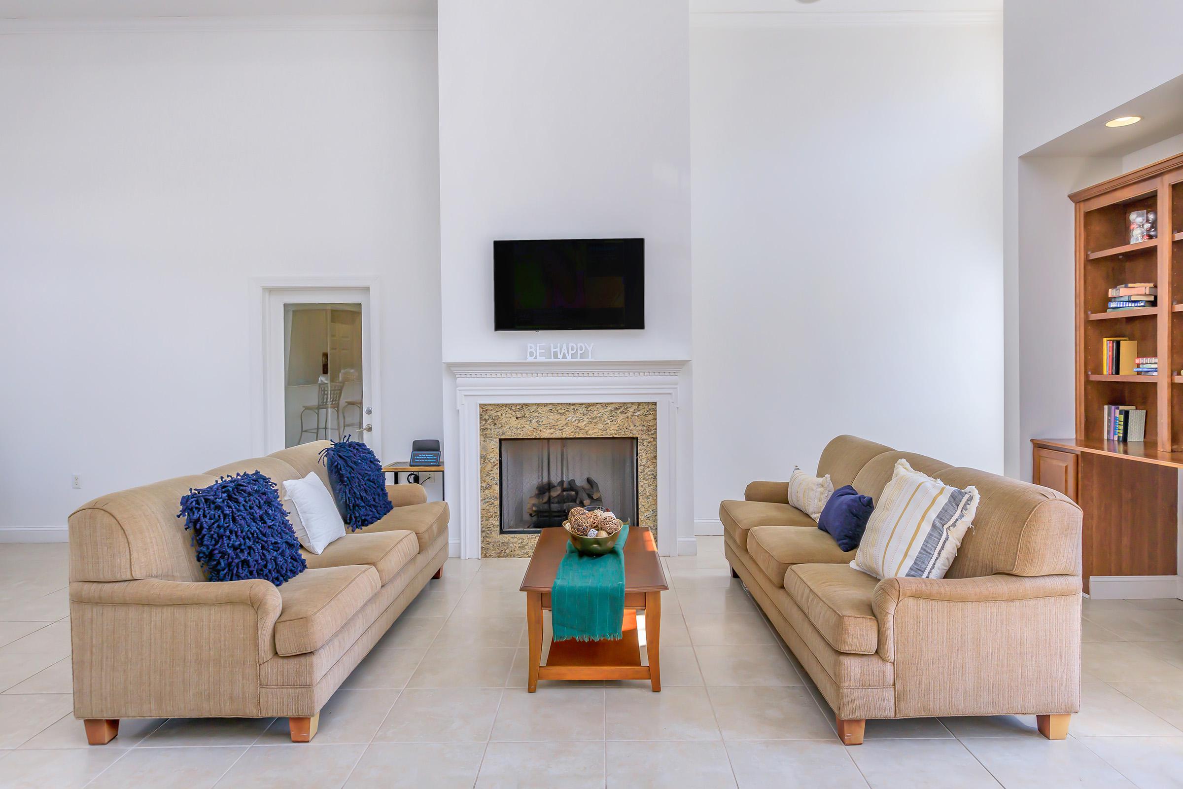 a living room filled with furniture and a fire place