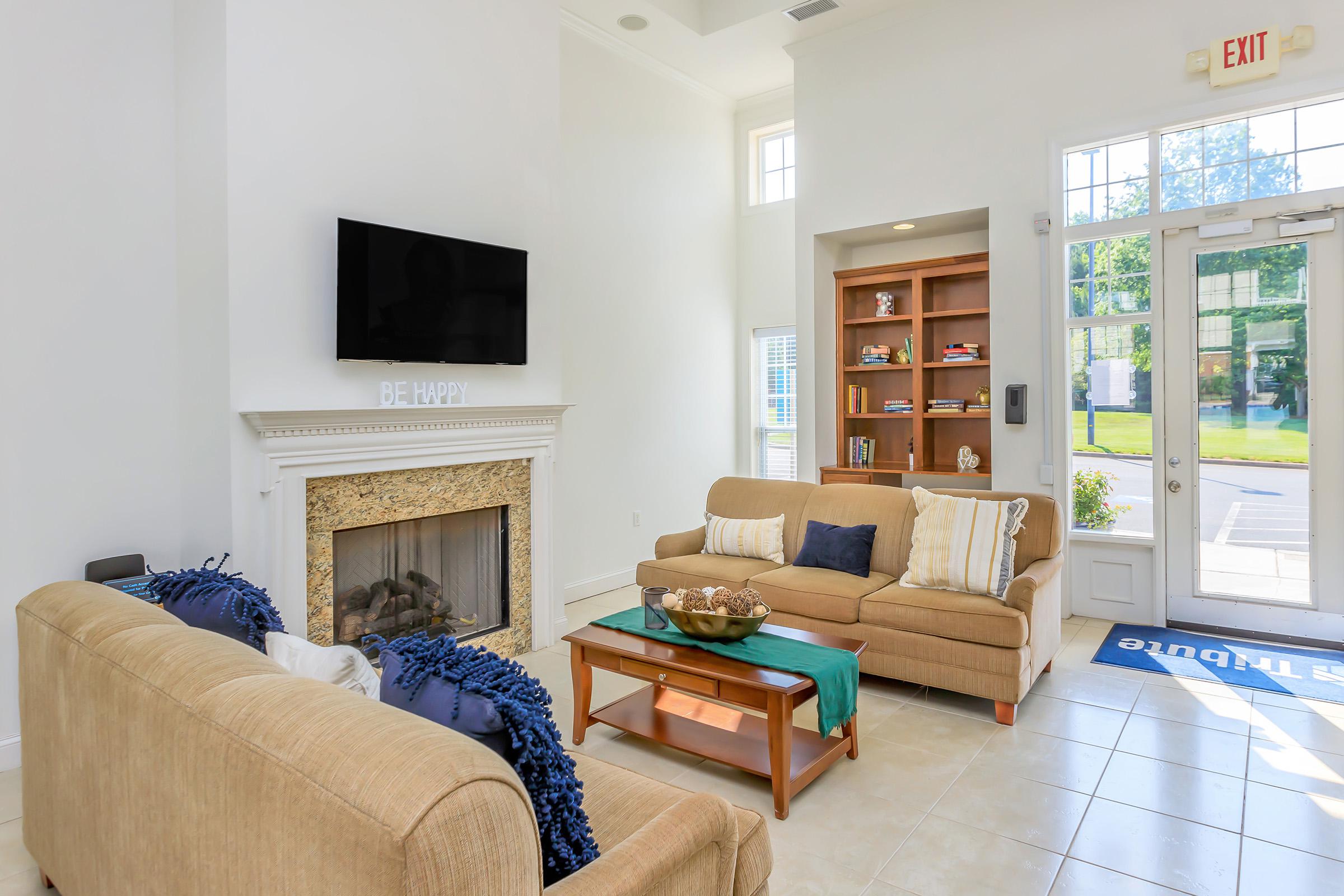 a living room filled with furniture and a fireplace