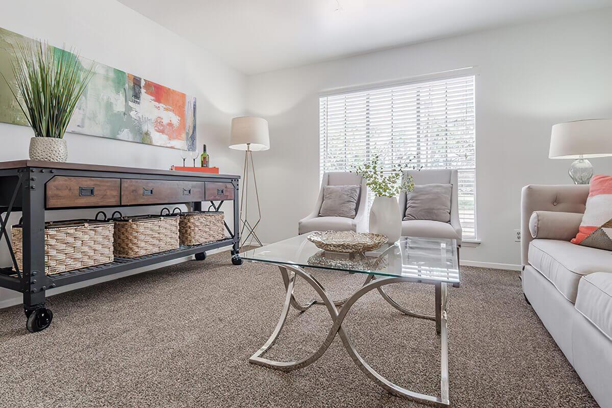 a living room filled with furniture and a large window