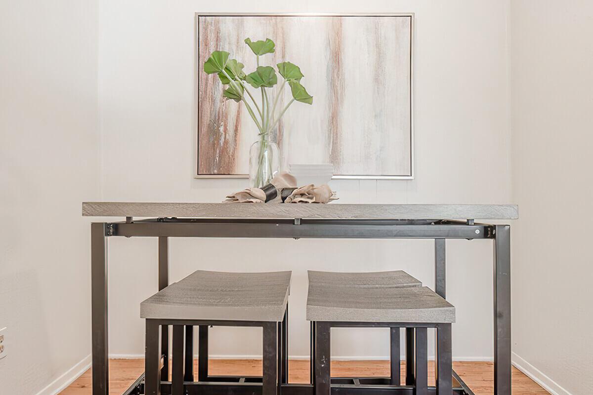 a room filled with furniture and vase of flowers on a table