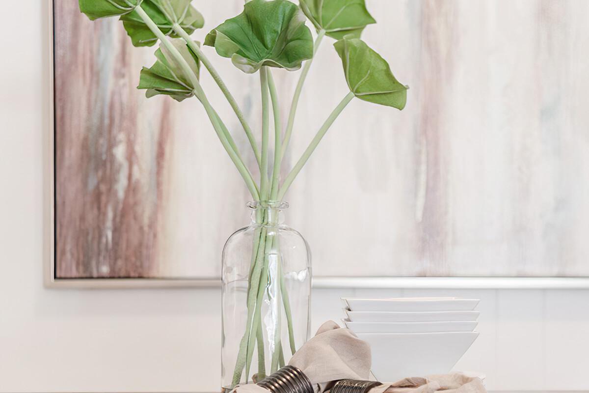 a vase with a flower on a plant