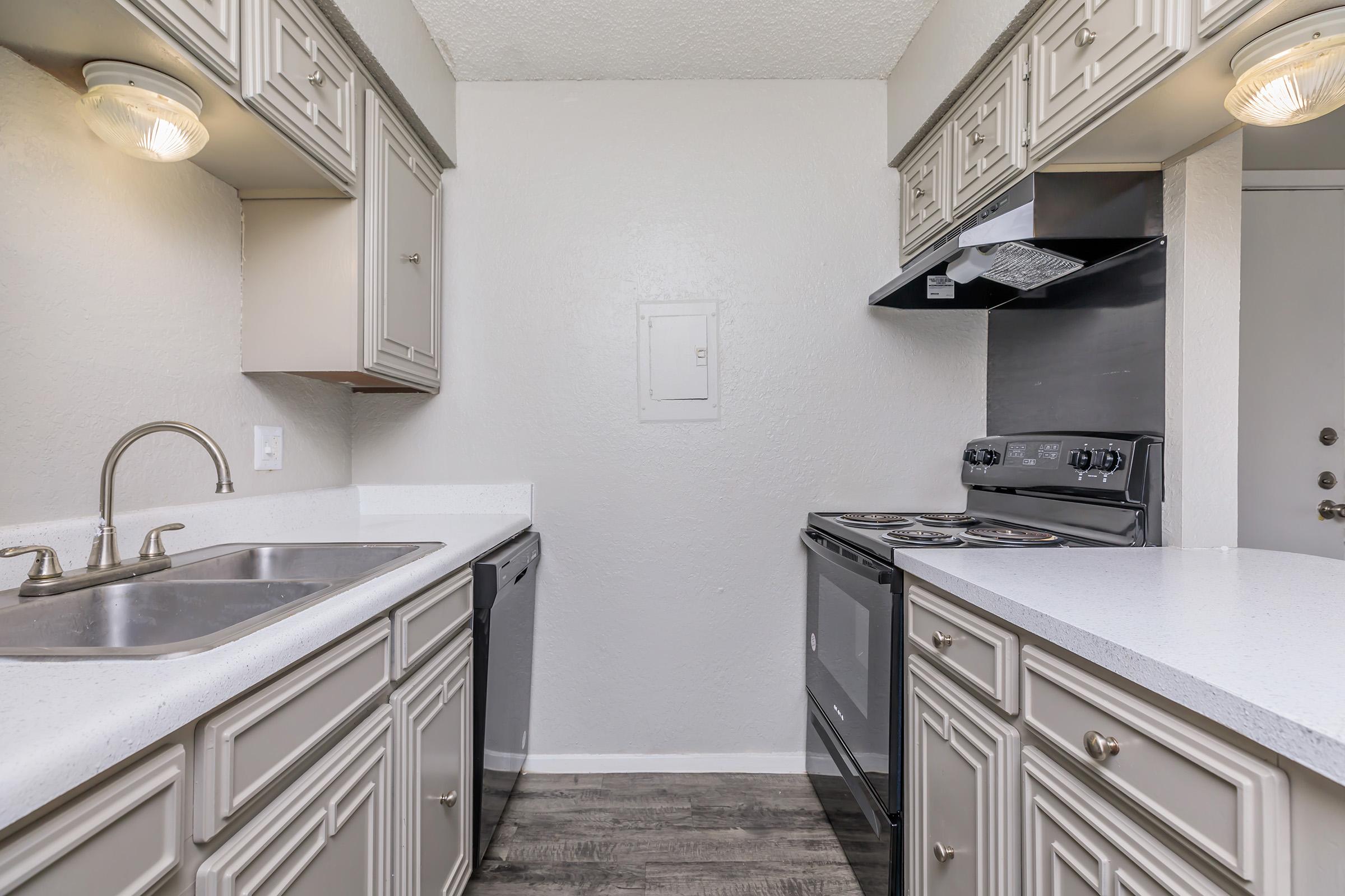 a kitchen with a stove and a sink