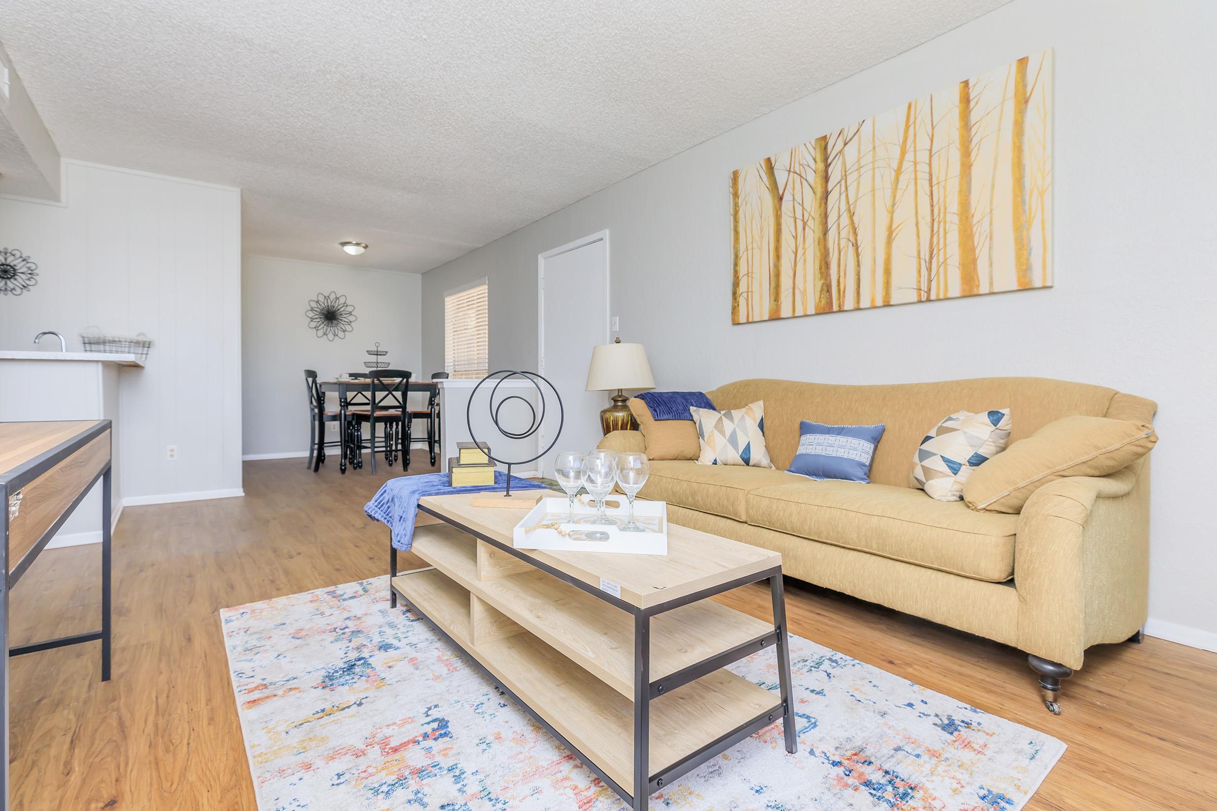 a living room filled with furniture and a rug