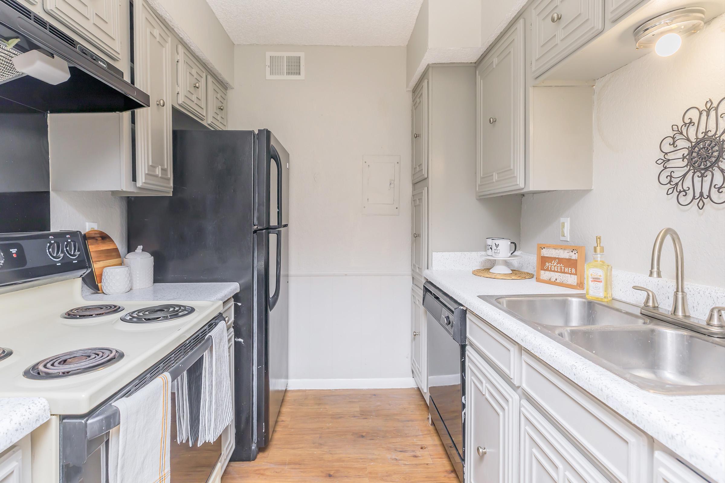 a kitchen with a stove sink and refrigerator